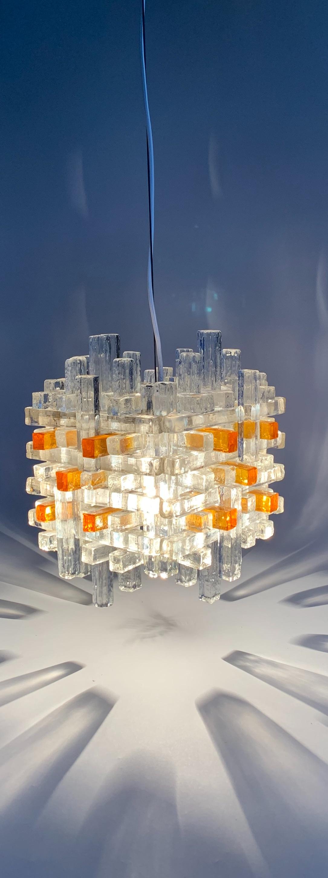 A 'jewel like' Poliarte chandelier light with a prism pattern of cast glass rods (clear and amber color).