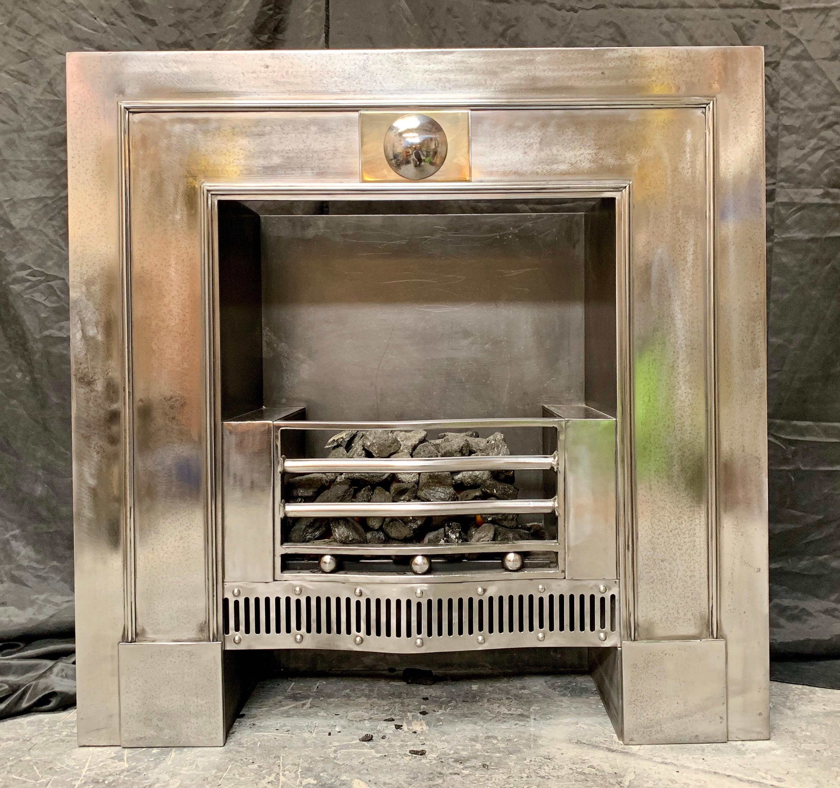 A medium sized 19th century Regency style polished register fireplace insert of handsome proportions. A four bar polished fire grate with three cushion ball spacers above a serpentine pierced steel apron, the central tablet encompassing a polished