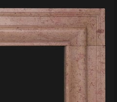 A Polished Bolection Chimneypiece in Red-Veined Limestone