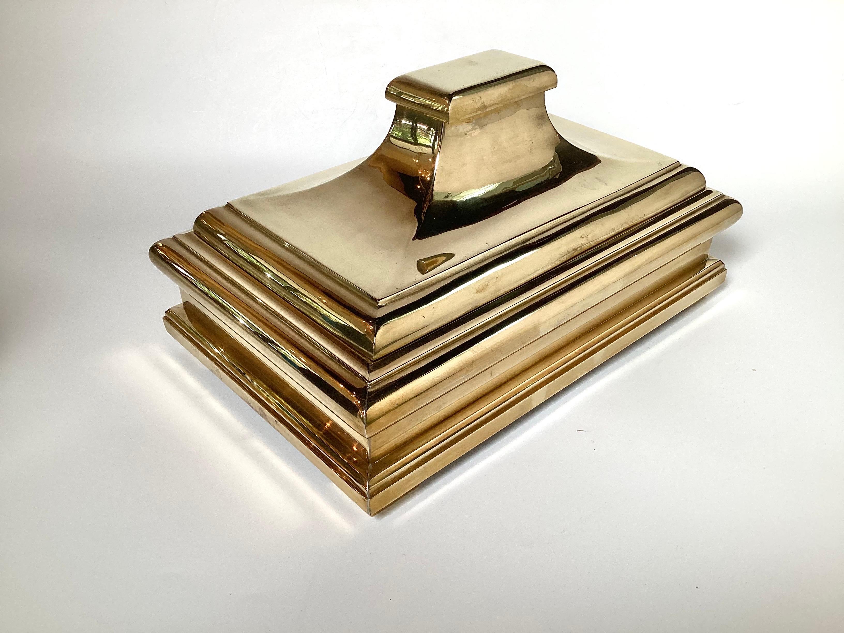 A chic and stylish cast brass table box by Chapman 1978.  The pagoda form box with lid with a black velvet interior, 15 inches wide, 9.5 inches deep, 8 inches tall.  