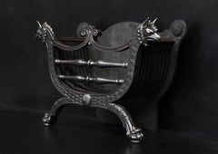 A Polished Cast Iron Firegrate with Griffin Heads