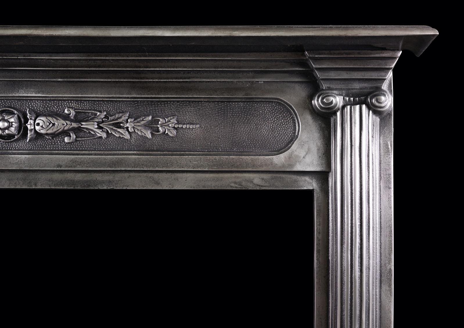 A polished cast iron fireplace in the classical style. The raised foliate detail to frieze flanked by split reeded columns with Doric capitals above. English, 19th century.

Shelf Width: 1215 mm 47 ?