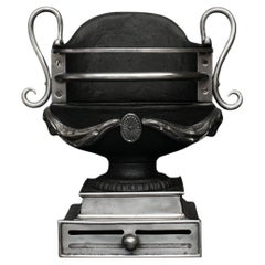 A Polished Cast Iron Urn Firegrate in the Regency Style