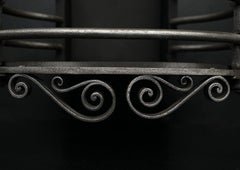 A Polished Iron Arts and Crafts Firegrate