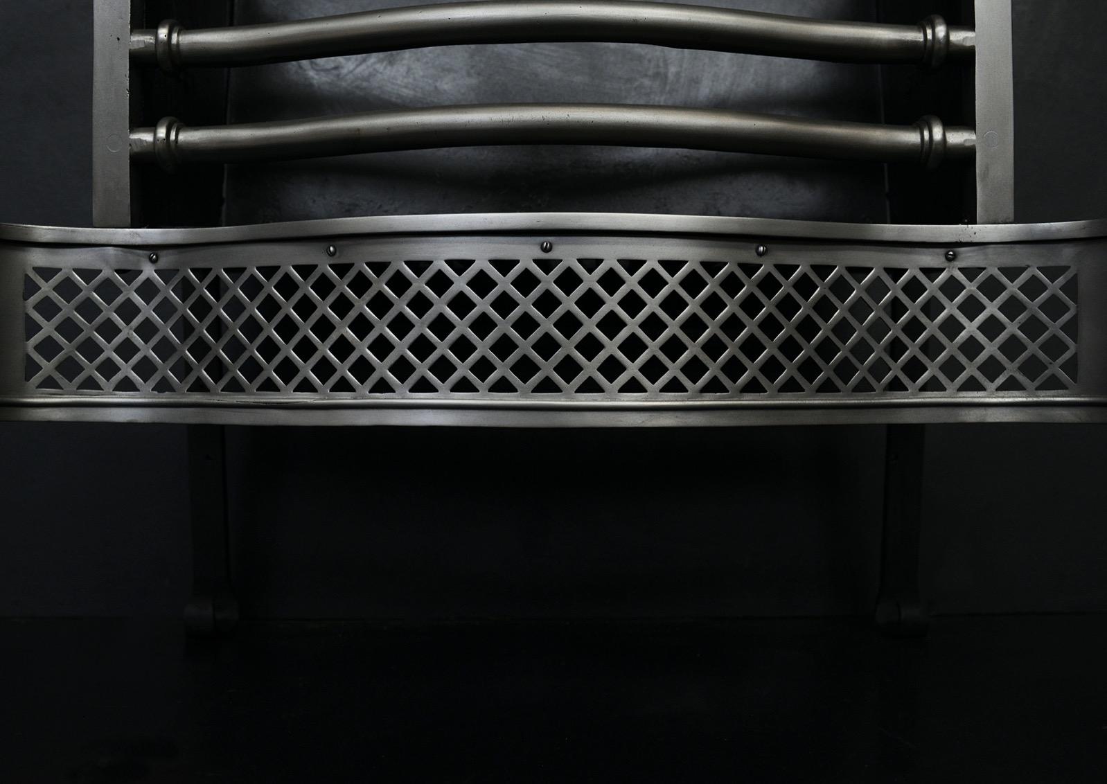 A polished steel firegrate in the Georgian style. The tapering legs surmounted by urn finial. The bowed front bars with crosshatch fret below. English, 20th century. 

Width At Front:	690 mm      	27 ⅛