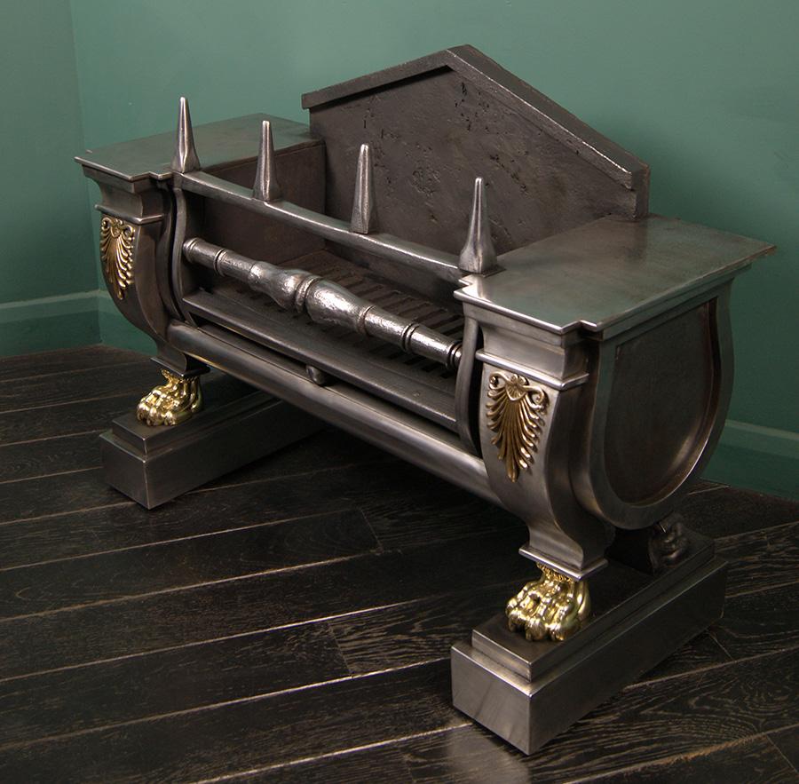 A polished steel Regency sarcophagus grate of superb build-quality with all cast-iron surfaces overlaid with riveted bright-cut steel for a magnificent polished finish. Details include: fine brass acanthus, delicate paw-feet and pinnacle log-stops.