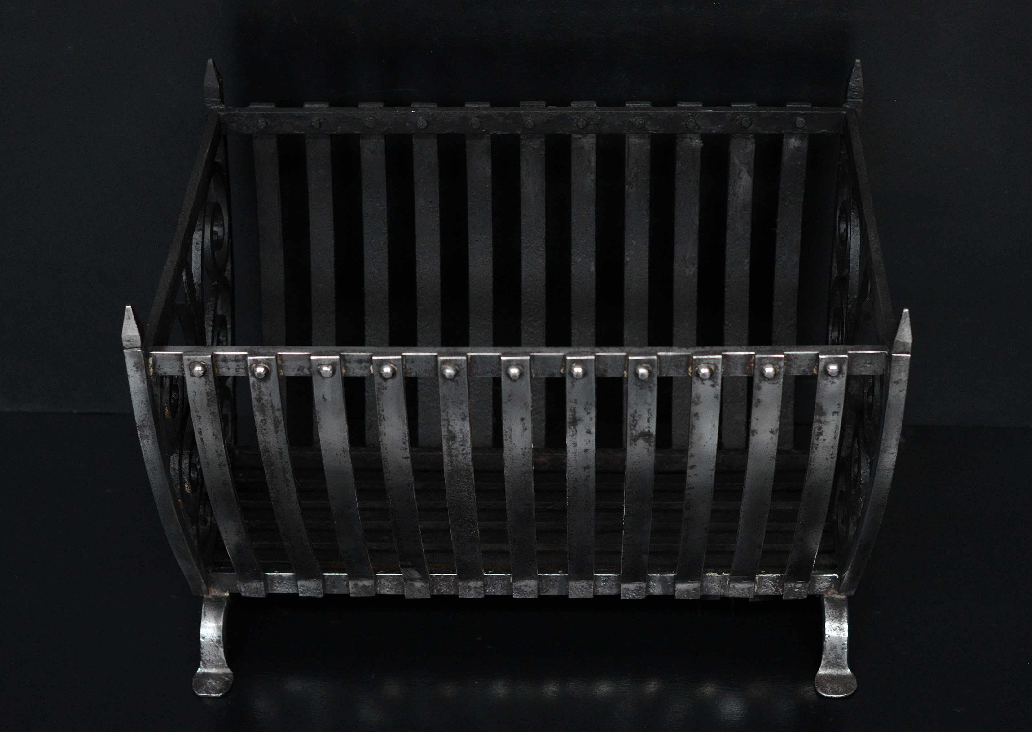 A polished wrought iron fire basket with shaped front bars and decorative scroll work to ends. Shaped feet. Suitable for burning substantial logs. English, early 19th century.

Width At Front:	640 mm      	25 ¼