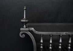 A Polished Wrought Iron Firegrate
