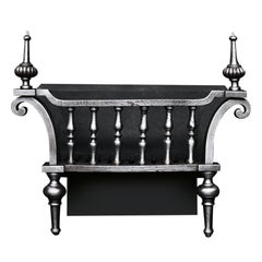 A Polished Wrought Iron Firegrate