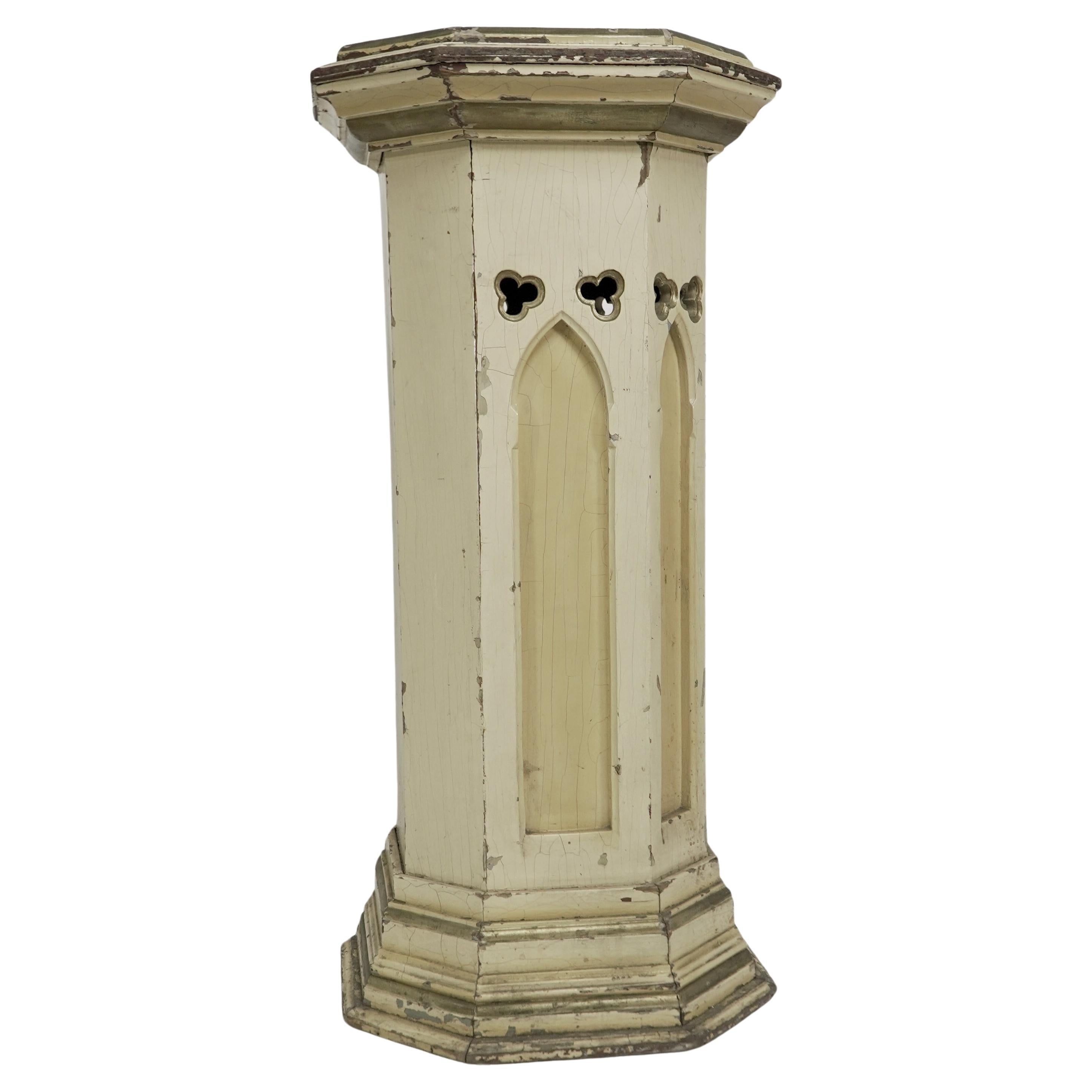 A polychrome painted octagonal pedestal with a graduated molded edge to the top