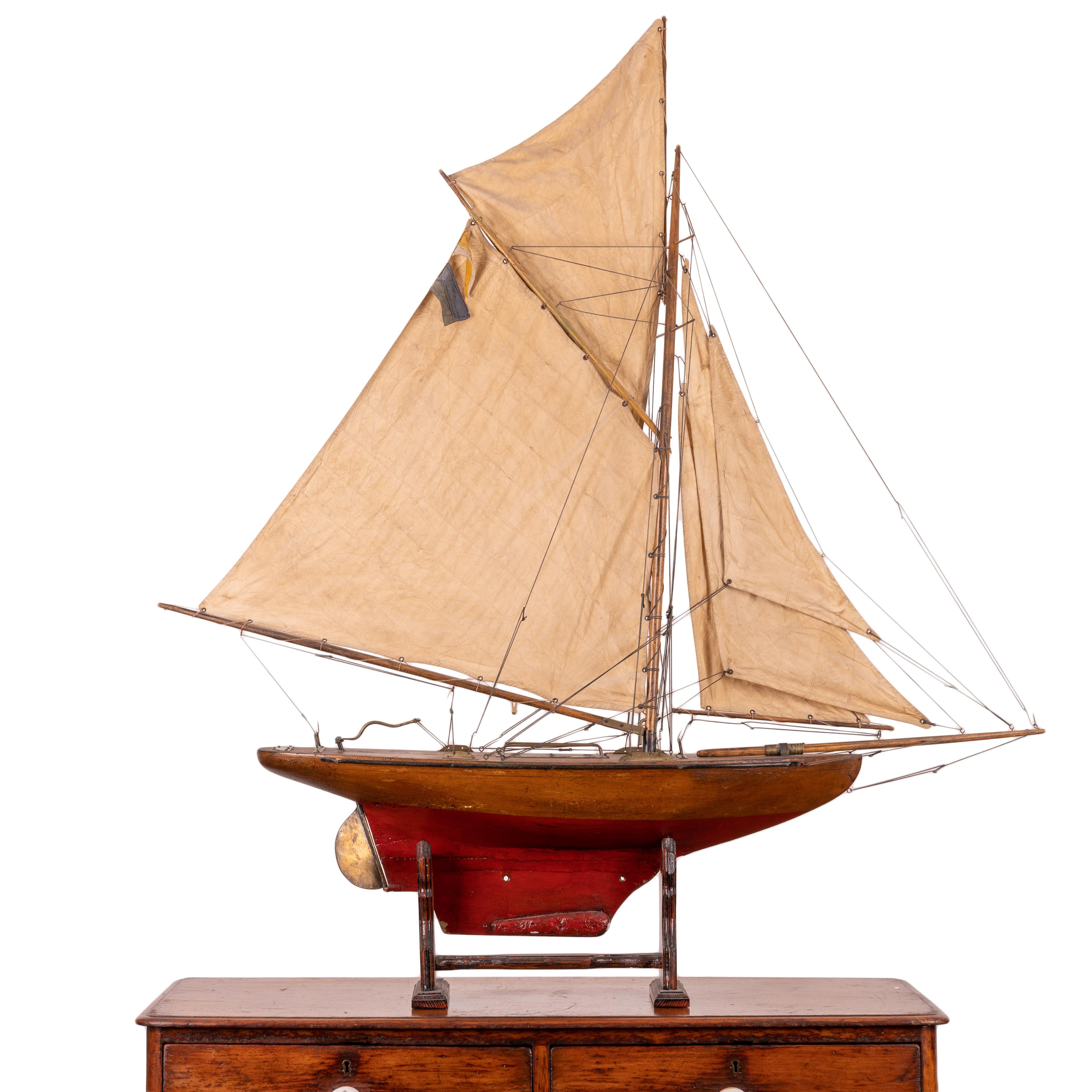 A fully rigged pond yacht on display stand, 1910s.

All original paint, riggings and five sails.

49 ½ inches wide by 8 ½ inches wide by 53 inches tall