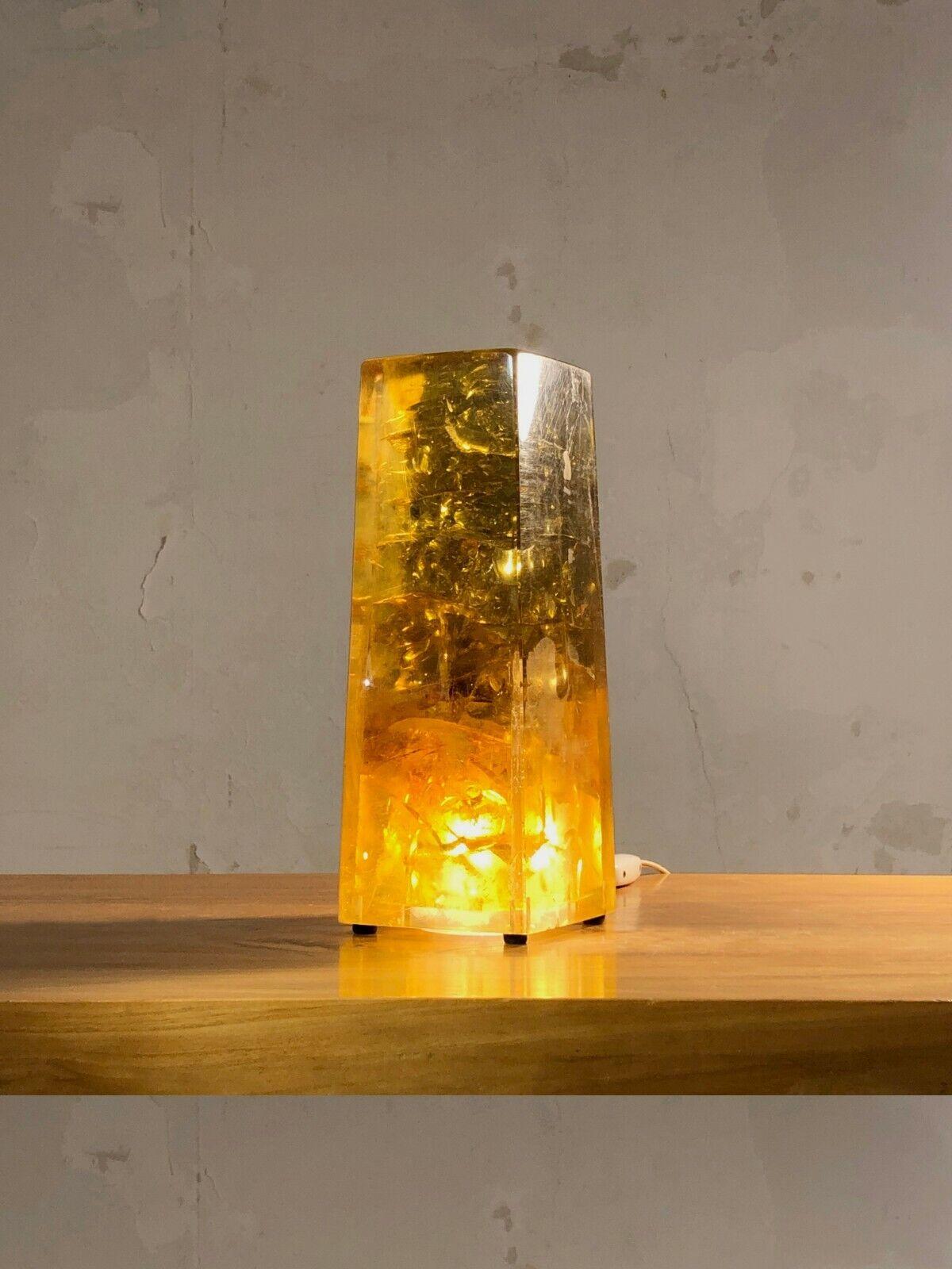 DESCRIPTION: An exceptional and sculptural monolythic table lamp or night light, Post-Modernist, Pop, Space-Age, in a block of massive yellow amber fractal resin, illuminated transparently by a bulb recessed in the center of the base of the lamp,