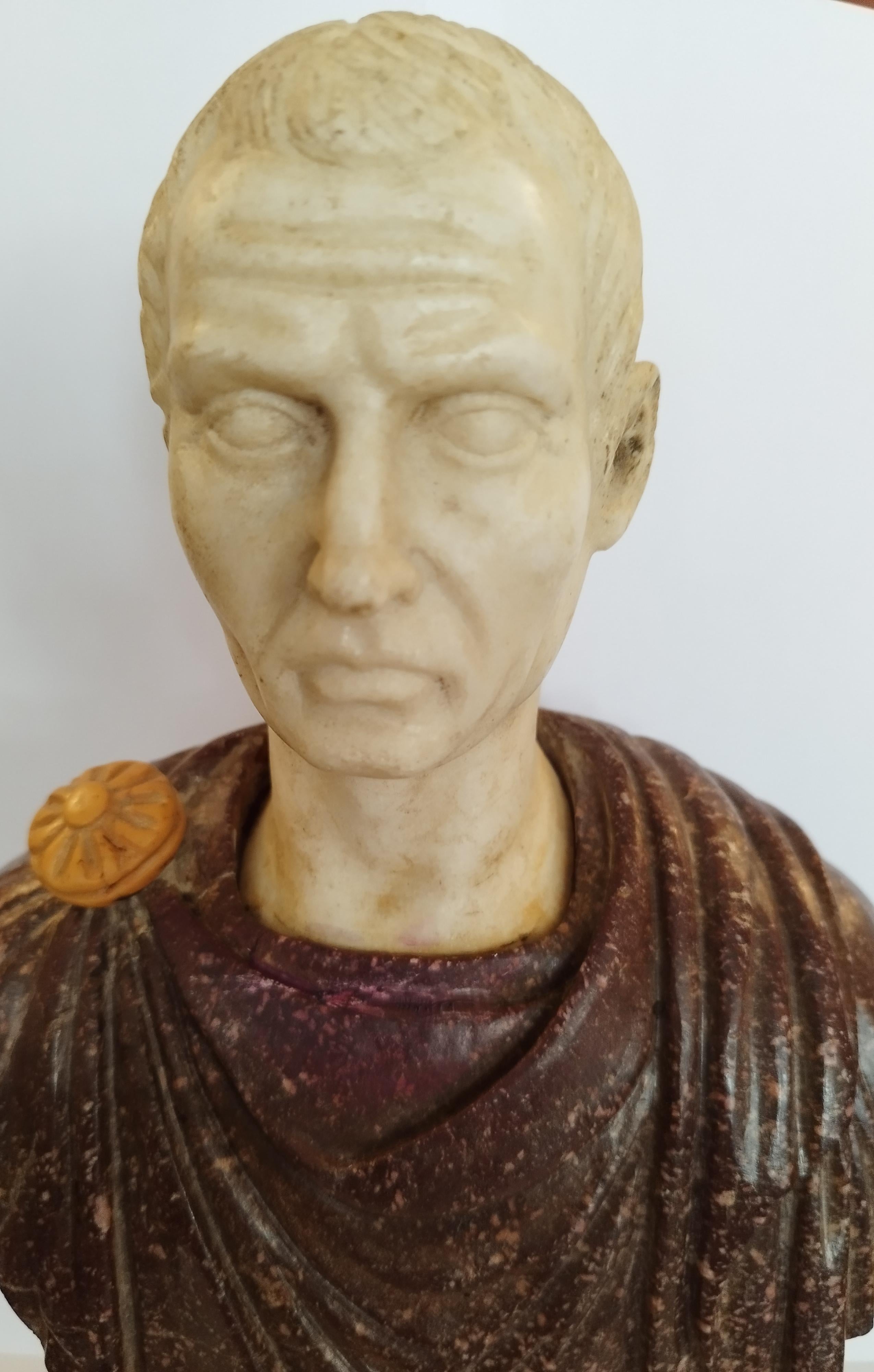 A rare and impressive bust of Julius Caesar .
the clothing is carved in porphyry, the head is in Carrara marble and the pedestal is in yellow marble of Siena.
late 19th or early 20th century.
