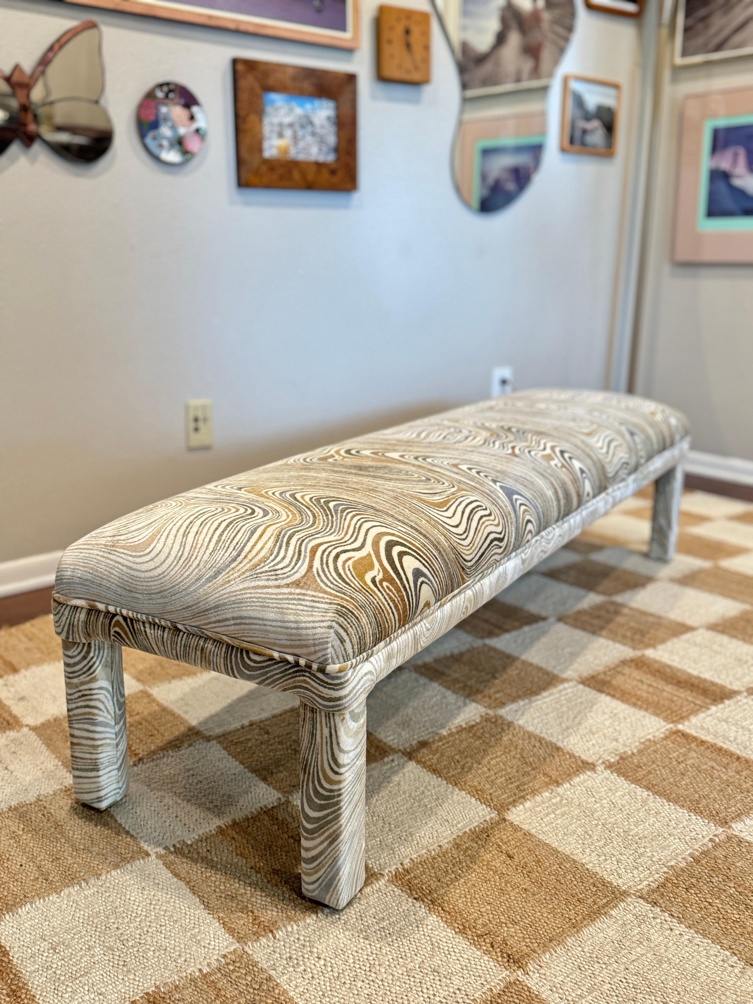 A post modern parsons style bench in the style of Milo Baughman, circa 1970s. Recently reupholstered in a neutral wavy fabric. In excellent condition and structurally sound.

15.5” H x 60” W x 17” D 