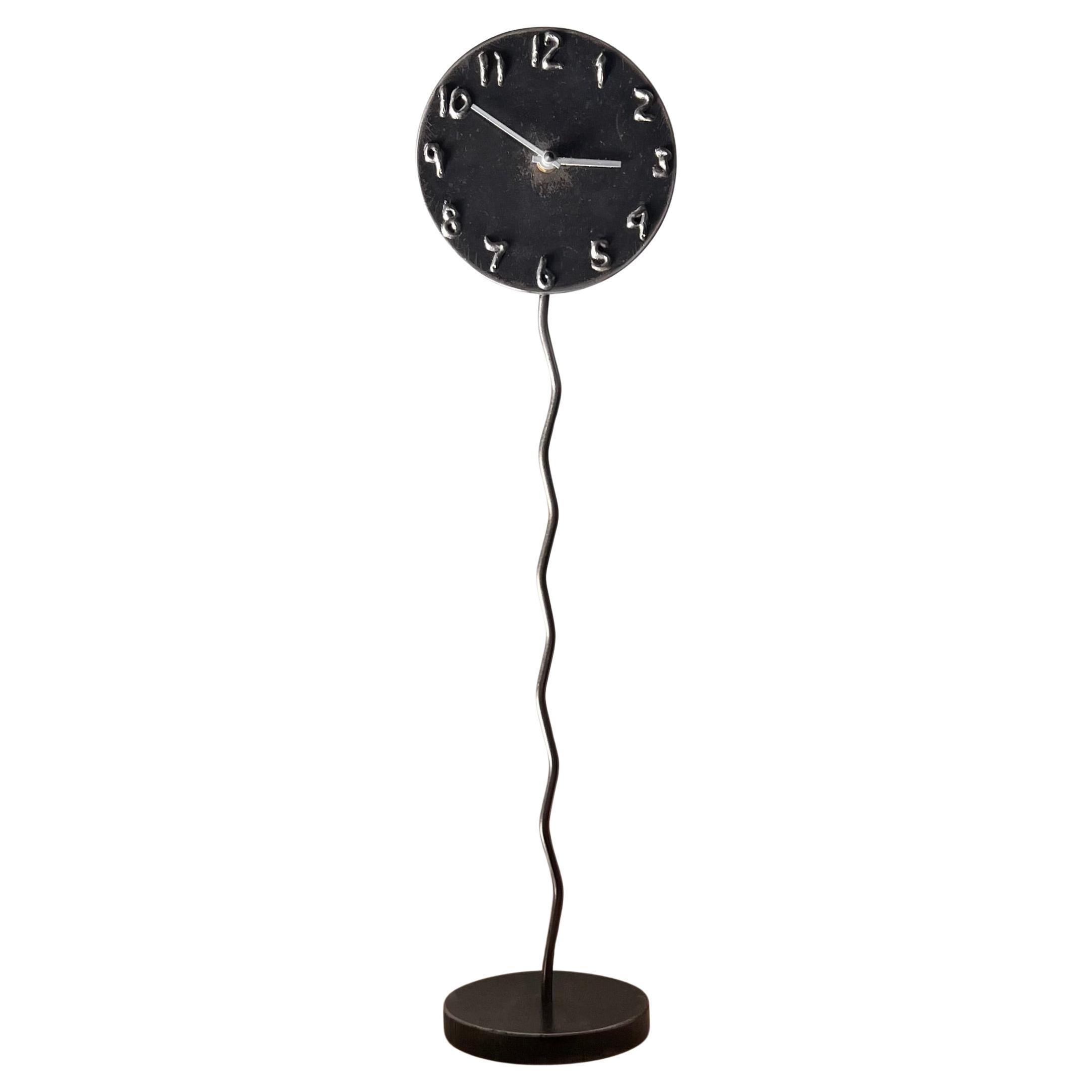 A postmodern sculptural welded metal clock by Jon Sarriugarte, signed, 1991