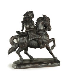 A powerful Japanese equestrian wood carving of a samurai by Yoshida Issen/Isshun