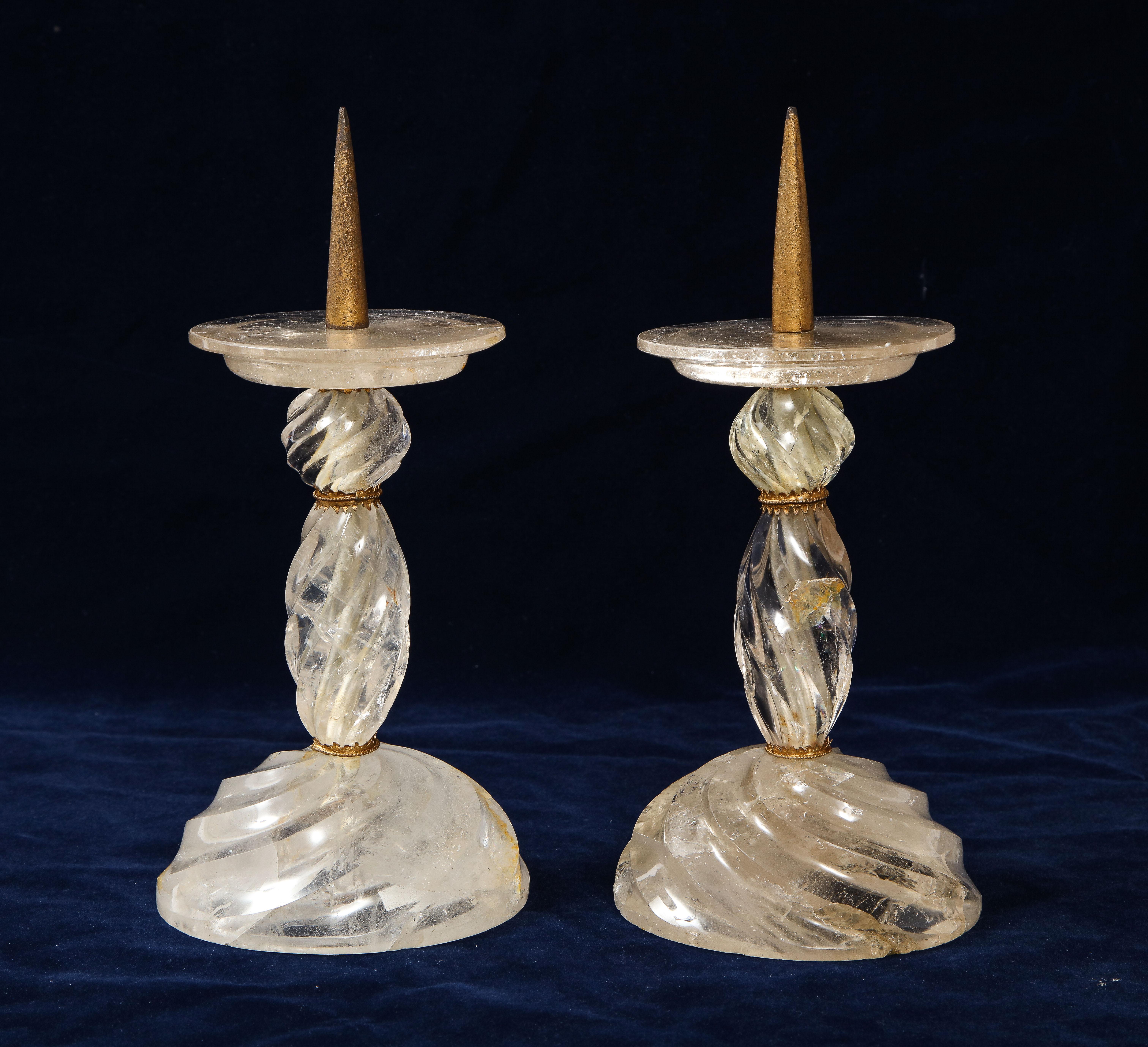 A Fabulous pair of French Louis XVI style dore bronze mounted hand carved rock crystal swirling spiked candlesticks, attributed to Baguès. Each candlestick is exceptionally hand carved and mounted on a beautiful dore bronze mount. Protruding from