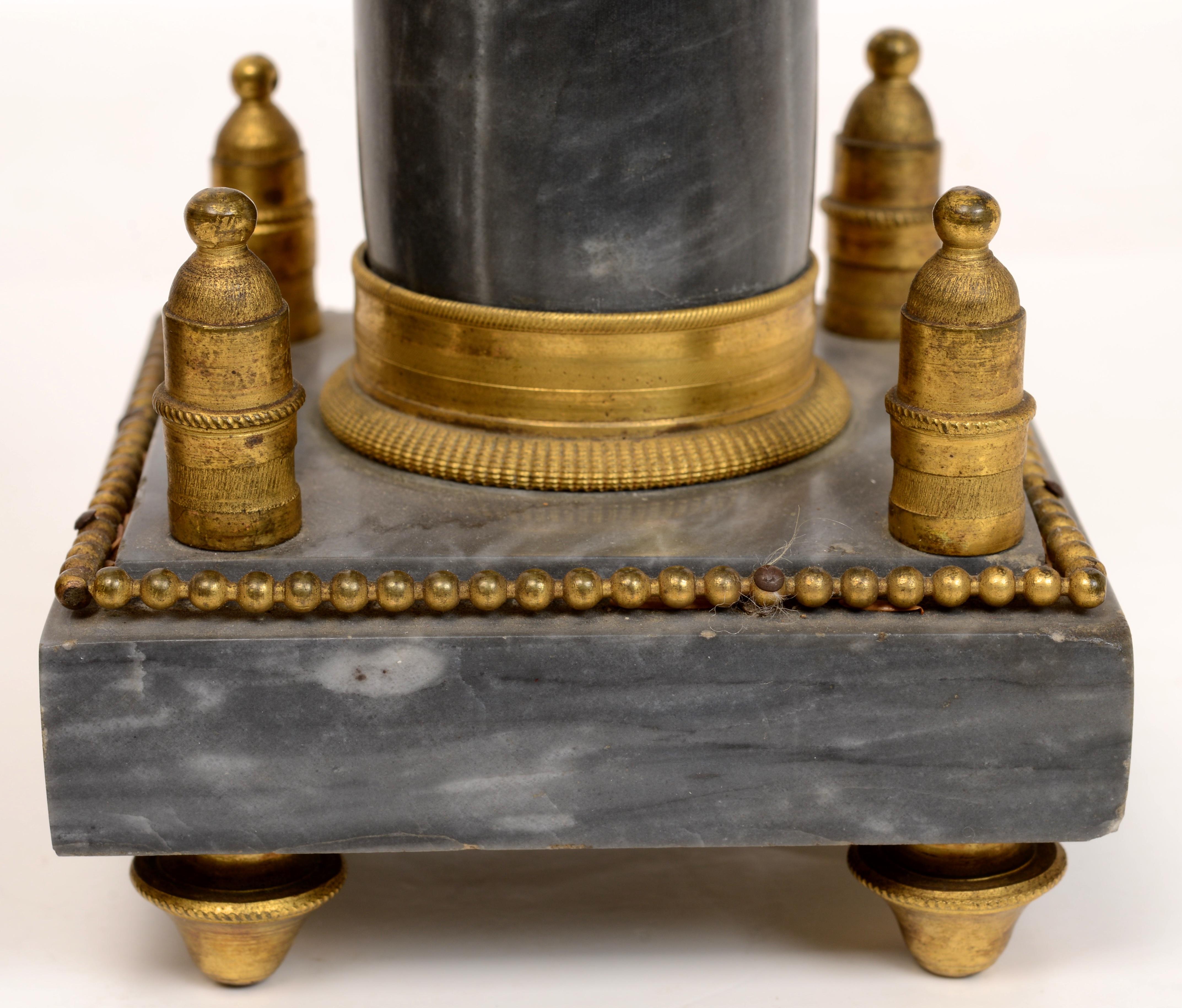 A pair of Louis XVI gilt bronze mounted gray and white mottled marble obelisks c1785. The base mounted with bollards in the corners. The body mounted with gilt bronze fittings. Probably adapted from a portico clock with a trace of earlier fittings.
