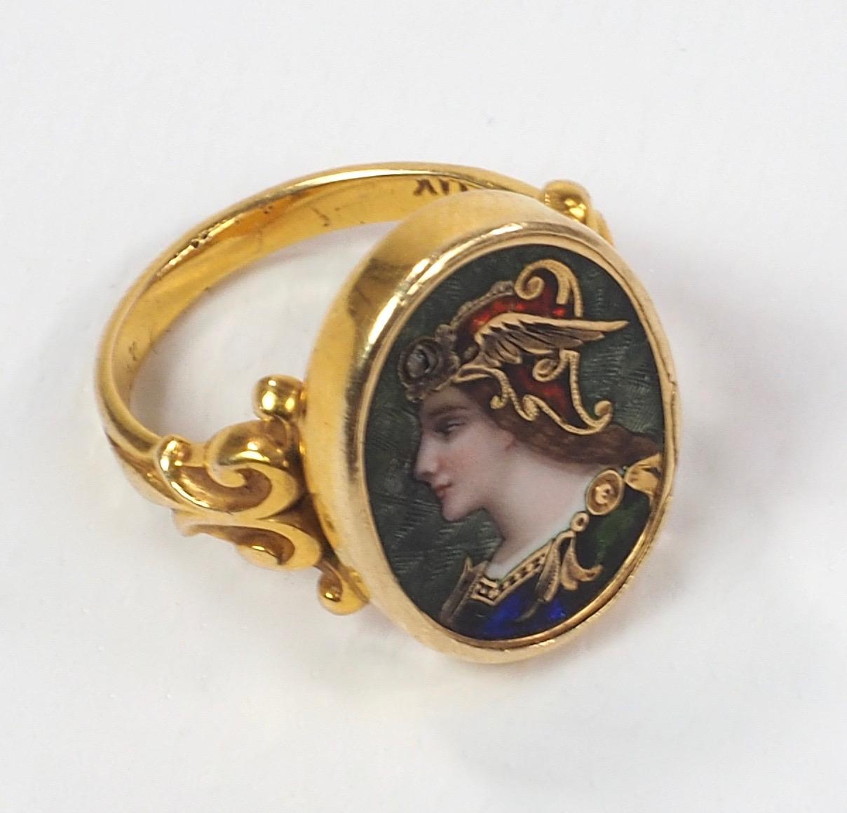 A Pre-Raphelite enamel and diamond ring depicting a Viking maiden, with a single rose-cut diamond accent to the winged headress,  finely enamelled with gold mount.
The Pre-Raphaelites formed one of the four great artistic movements between the