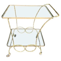 A pretty French 1950s brass faux bamboo bar trolley by Maison Baques