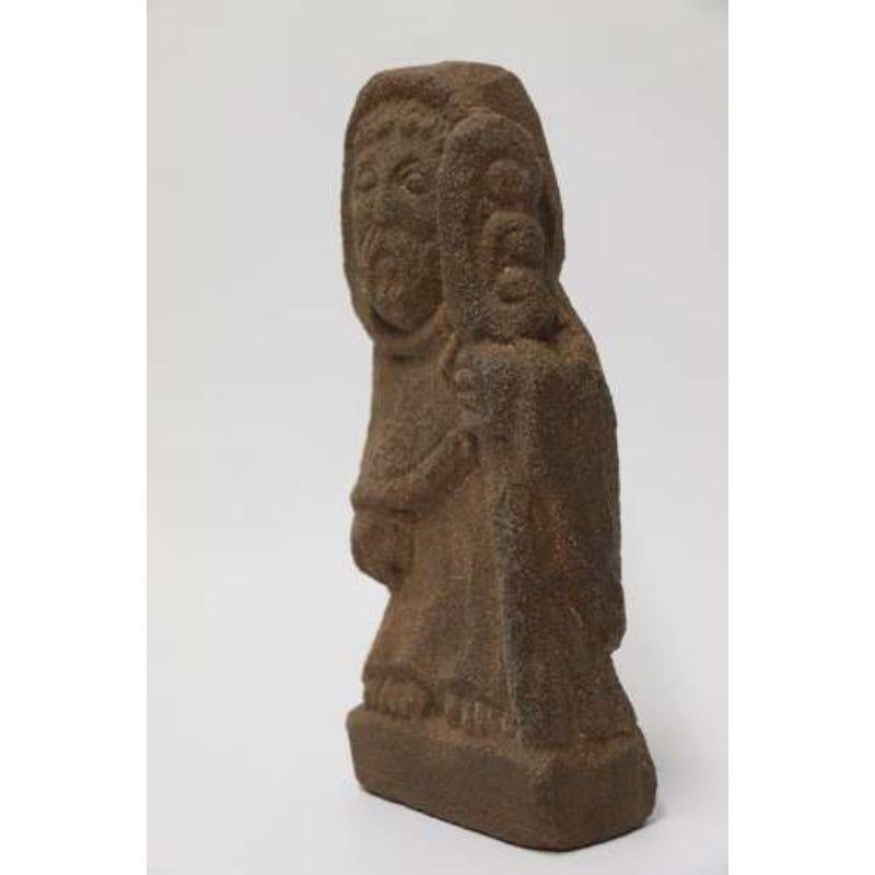 A Primitive Carved Sandstone Celtic Style Figure

This interesting piece is carved in a harder type sandstone which has a high silica content. It depicts an early Celtic style bearded figure wearing a large hooded cloak and holding an ornate