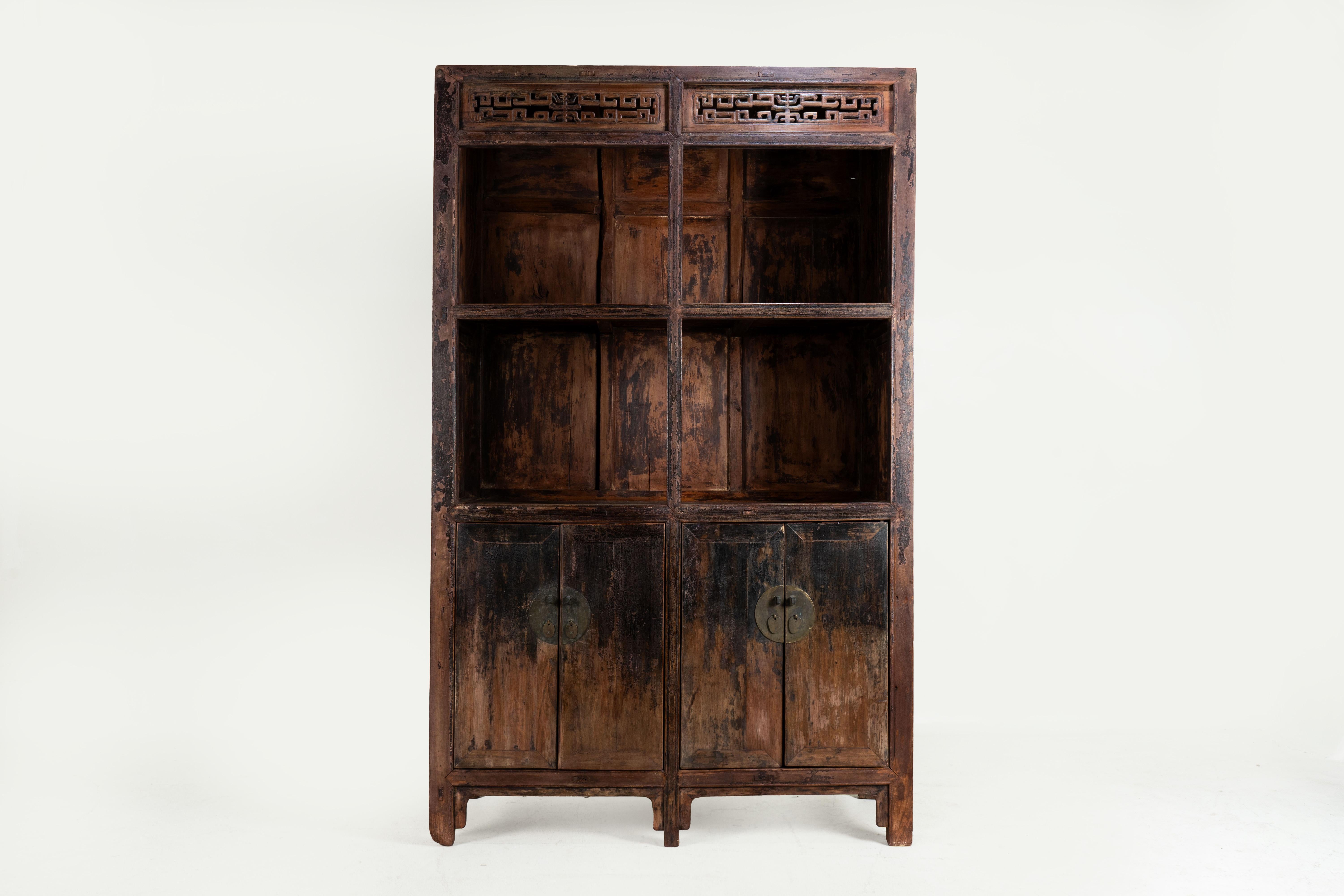 This antique scroll shelf from Shanxi, China, dates back to the early Qing dynasty period around the 1680's. Crafted from elmwood, a durable material known for its resistance to splitting and breaking, it features an attractive grain pattern of