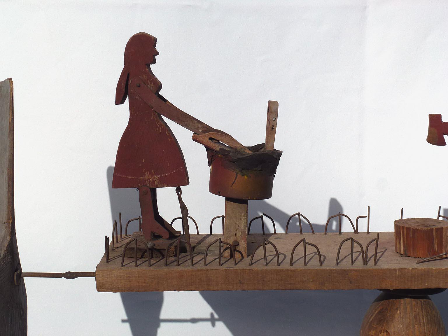 Mid-20th Century Primitive Whirligig with a Man Chopping Wood and a Woman Scrubbing Laundry For Sale