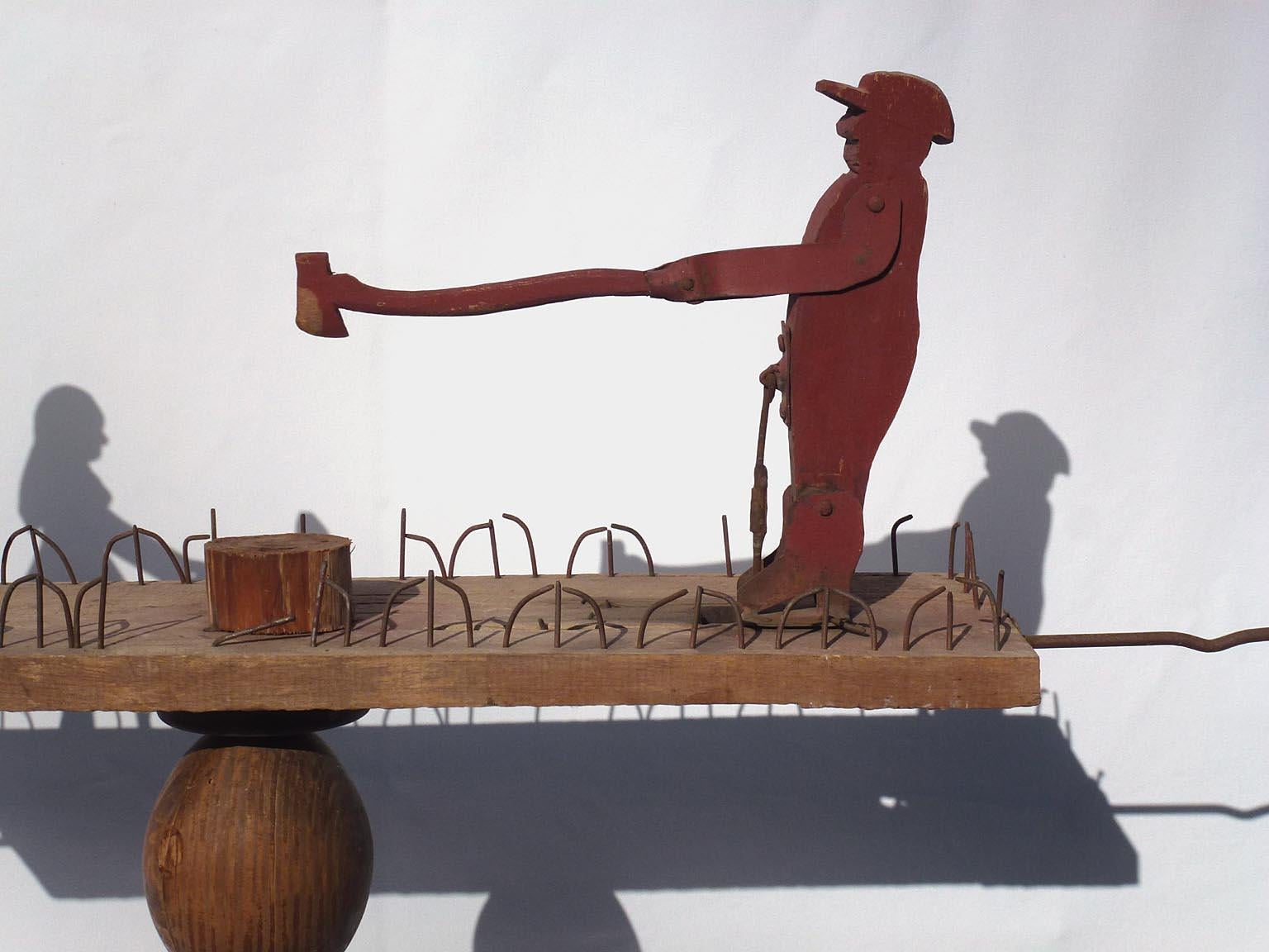Metal Primitive Whirligig with a Man Chopping Wood and a Woman Scrubbing Laundry For Sale