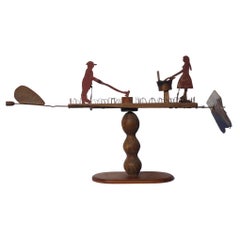 Vintage Primitive Whirligig with a Man Chopping Wood and a Woman Scrubbing Laundry