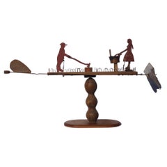 Primitive Whirligig with a Man Chopping Wood and a Woman Scrubbing Laundry