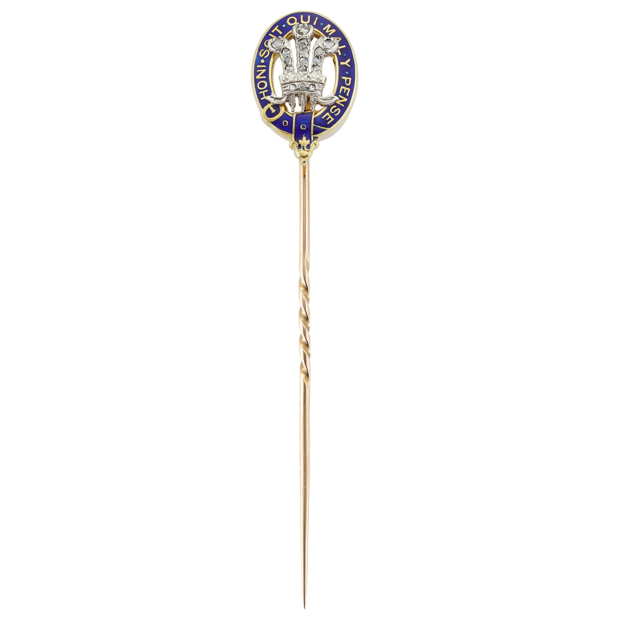 A Prince of Wales Royal Presentation stick-pin, the three feathers set with small rose-cut diamonds, surrounded by blue enamelled garter, to gold pin, circa 1905, unmarked, tested as 9ct gold, the jewelled part measuring 1.6 x 1cm, the pin measuring