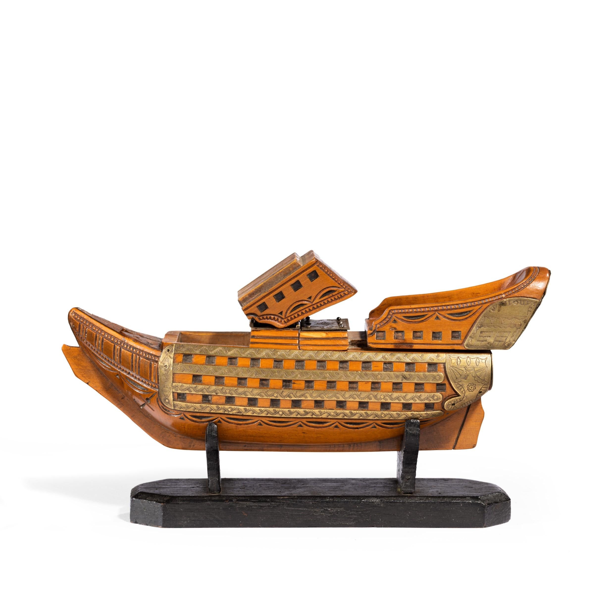 This double snuffbox shows a French Océan-class battleship. Constructed of walnut, the hinged bow and the poop sections opening to reveal compartments in her mid-ships and applied with incised brass bands below the gun ports and around the stern,