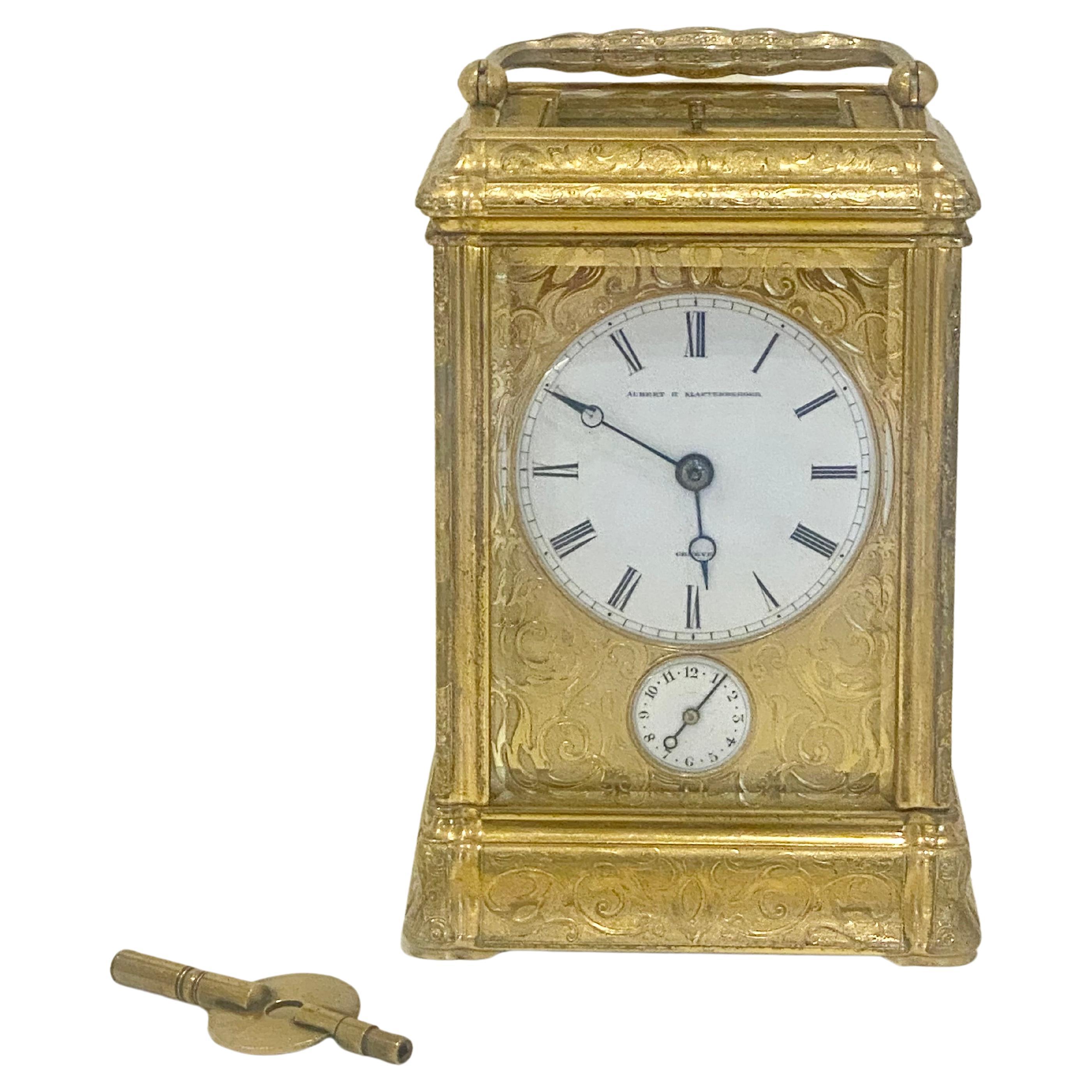 A fully all over engraved gilt bronze carriage clock geneve circa 1870 and retailed in London by Aubert & Klaftenberger.
The gorge case of characteristic design, profusely engraved to all sides with foliate scrolls and flowers on a matted ground,