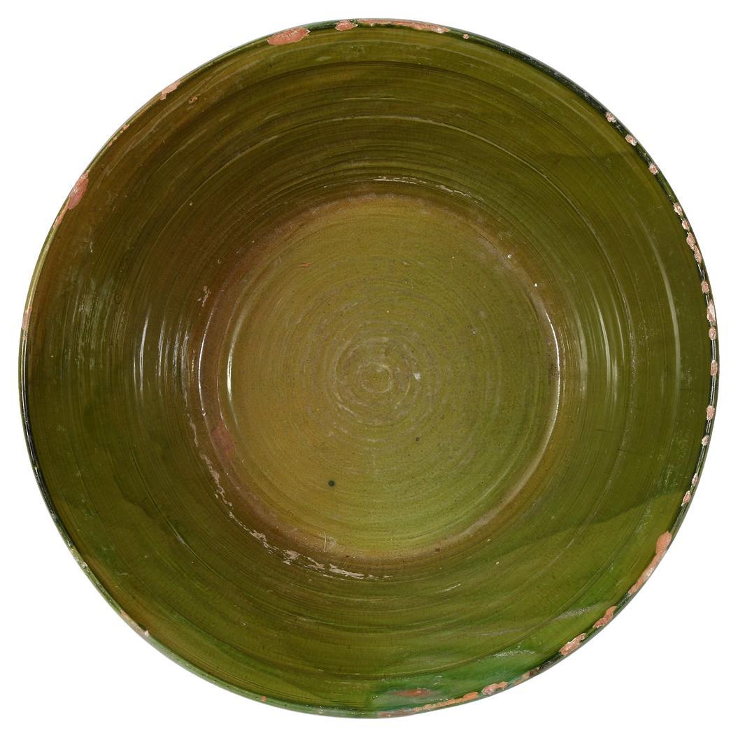 This provencal glazed terracotta bowl, hailing from 19th-century France, is a stunning example of traditional French craftsmanship. Often referred to as a 
