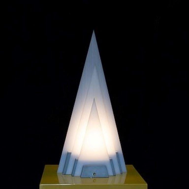 A single aluminium and white acrylic sculptural table lamp with three pyramid shapes in different sizes, late 1970s.