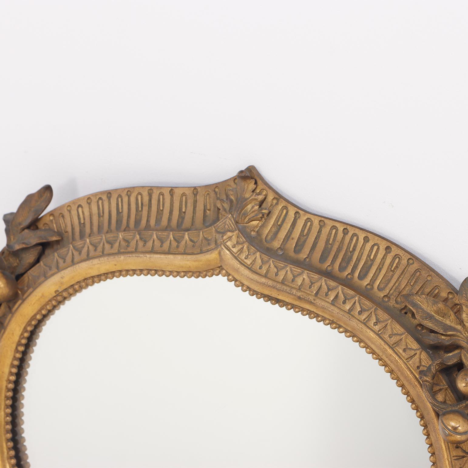 A quality cast bronze French wall mirror with nicely detailed border circa 1900. In Good Condition In Philadelphia, PA
