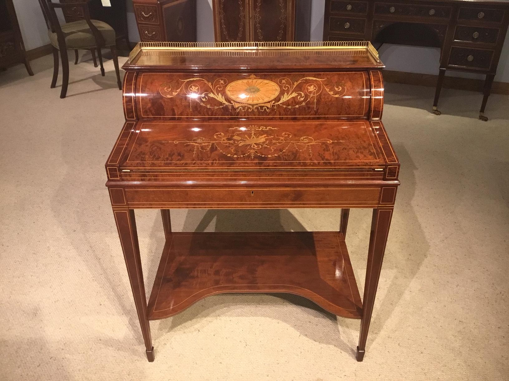 A stunning quality marquetry inlaid cylinder bureau by Maple & Co. of London. The brass balustrade gallery above the well figured mahogany super structure which has two fantastic marquetry and pen-work panels, one on the cylinder front and one to