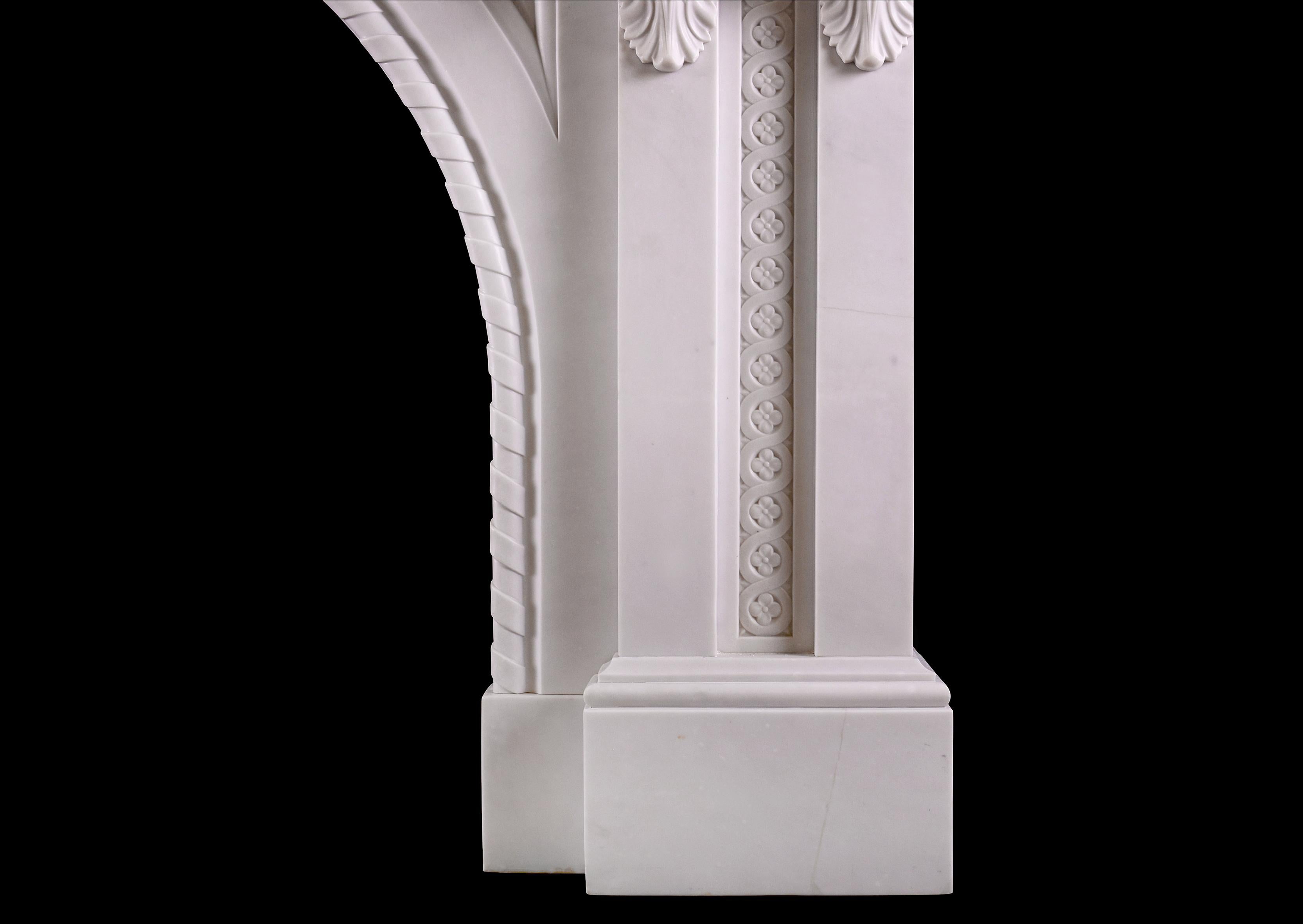 A fine quality period Victorian fireplace in Italian Statuary marble. The arched opening with panels and rope moulding, surmounted by carved guilloche motif and scrolled keystone to centre. The jambs each with pair of scrolled brackets with acanthus