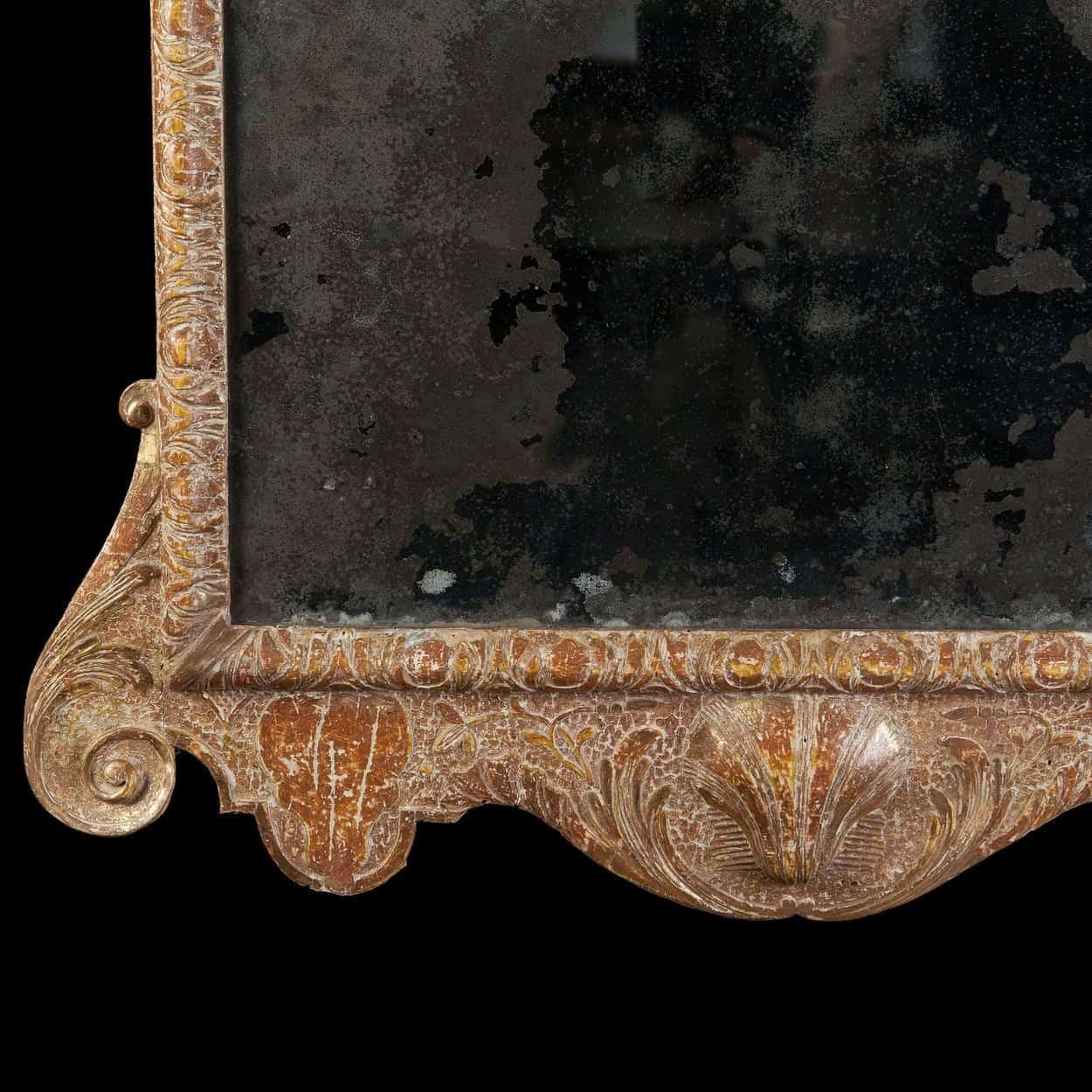 A rare Queen Anne gilt gesso pier mirror, retaining its original beveled mirror plate and gilding. The cresting bears the unusual feature of a carved bust in high relief below three feathers. In the manner of John Belchier.
England, circa