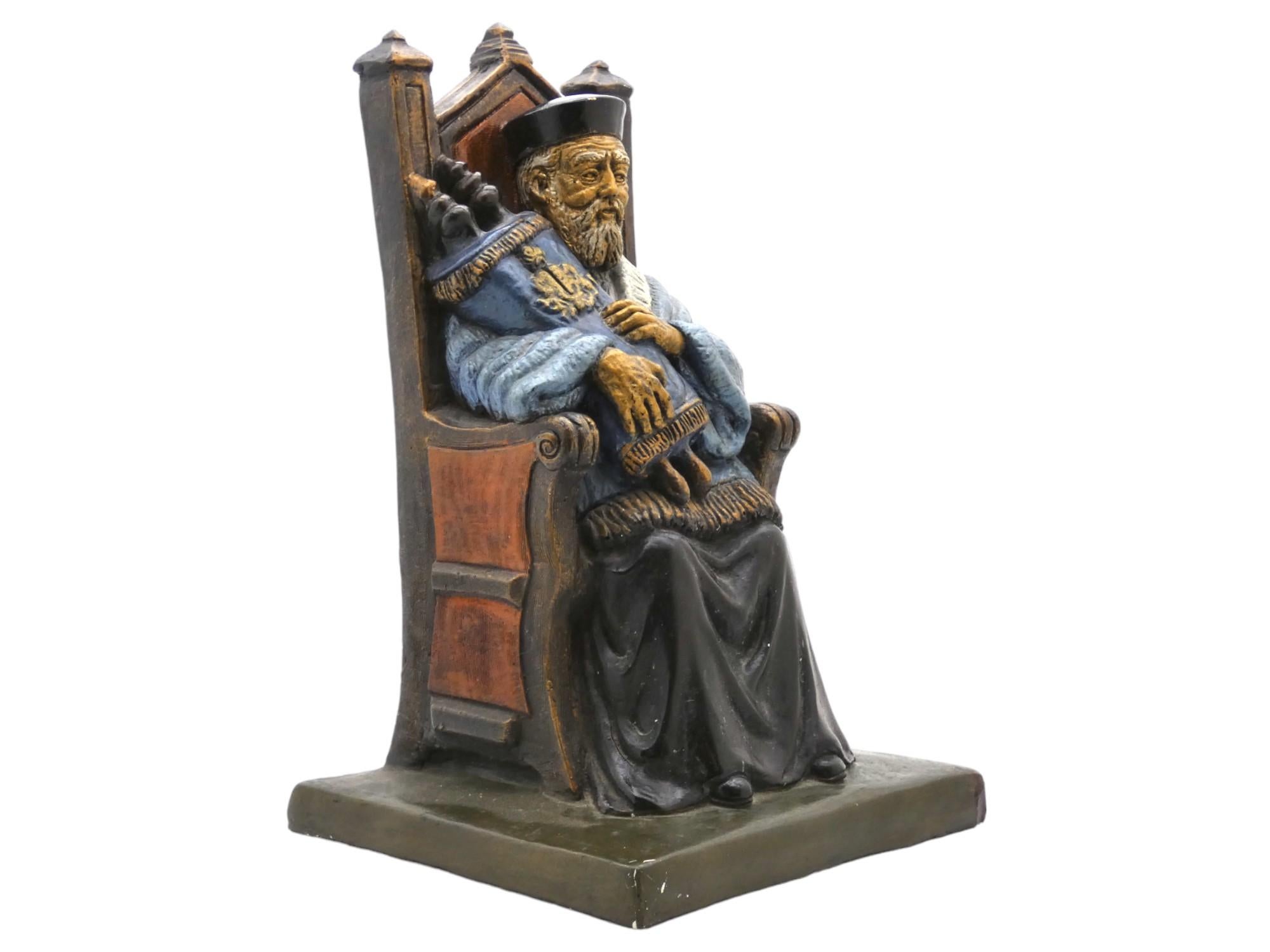 A painted plaster sculpture of a rabbi with a Torah from the mid-20th century reflects the artistic and cultural sensibilities of the time while using more accessible and affordable materials. 

 The sculpture has a folk art feel, with bright,
