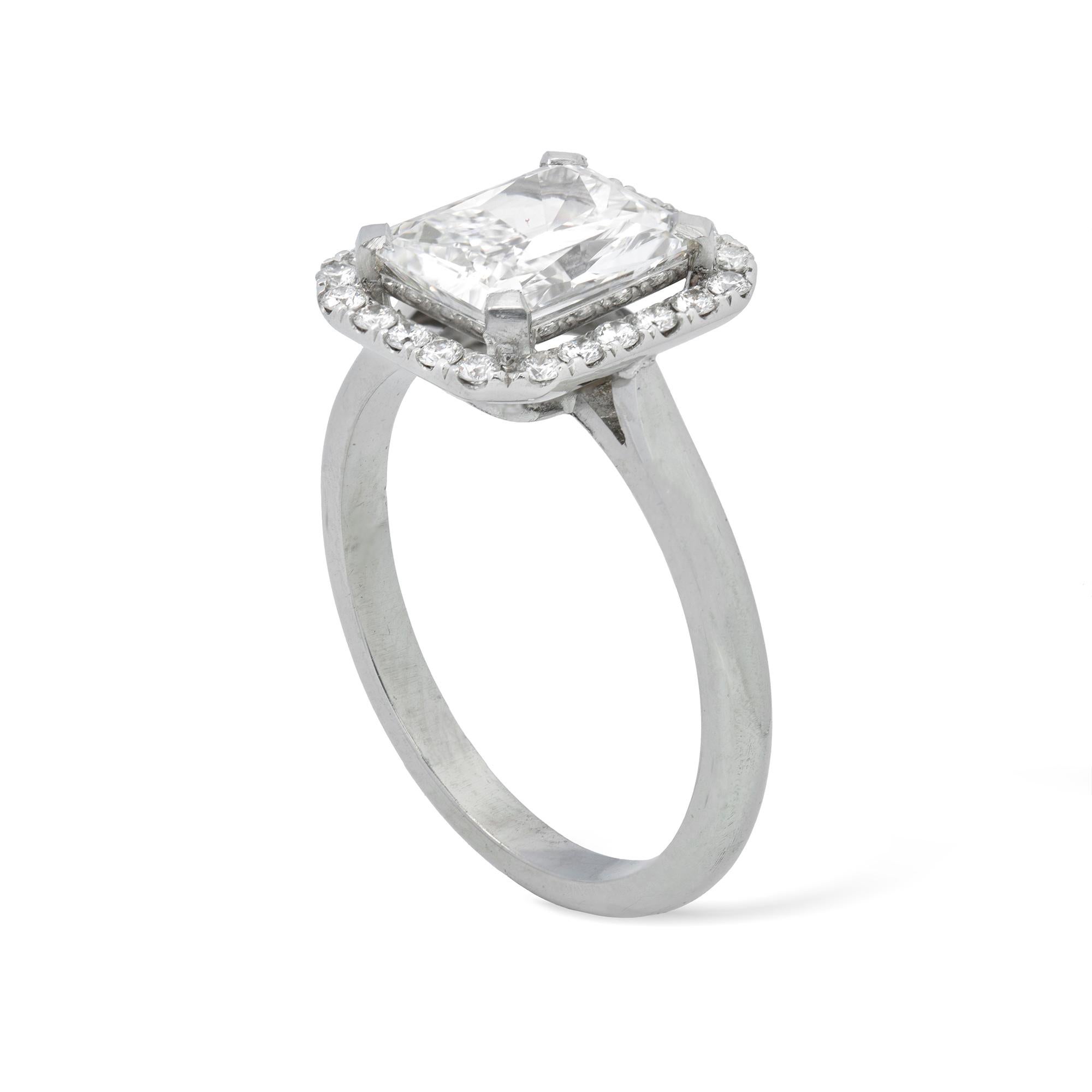 A rectangular diamond cluster ring, the radiant-cut diamond weighing 1.91 carats of D colour, VS1 clarity, GIA certificate, set to the centre of a round brilliant-cut diamond-set rectangular cluster to a white gold D-section shank, later hallmarked