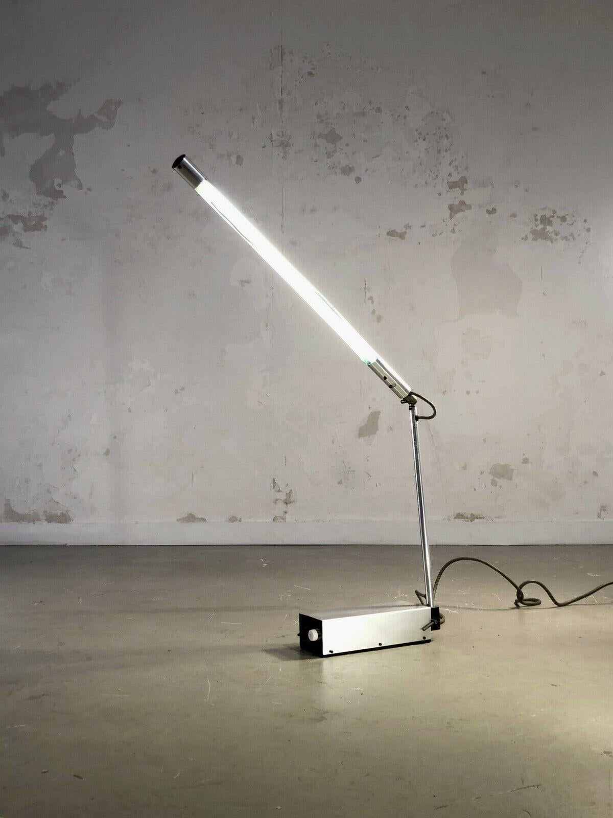 A rare table lamp, Post-Modernist, Memphis, Kinetic, Radical Design, Minimalist, rectangular base with aluminum cover housing a transformer, vertical axis and adjustable aluminum arm, fine neon lighting embedded in the arm, by Gerald Abramovitz,