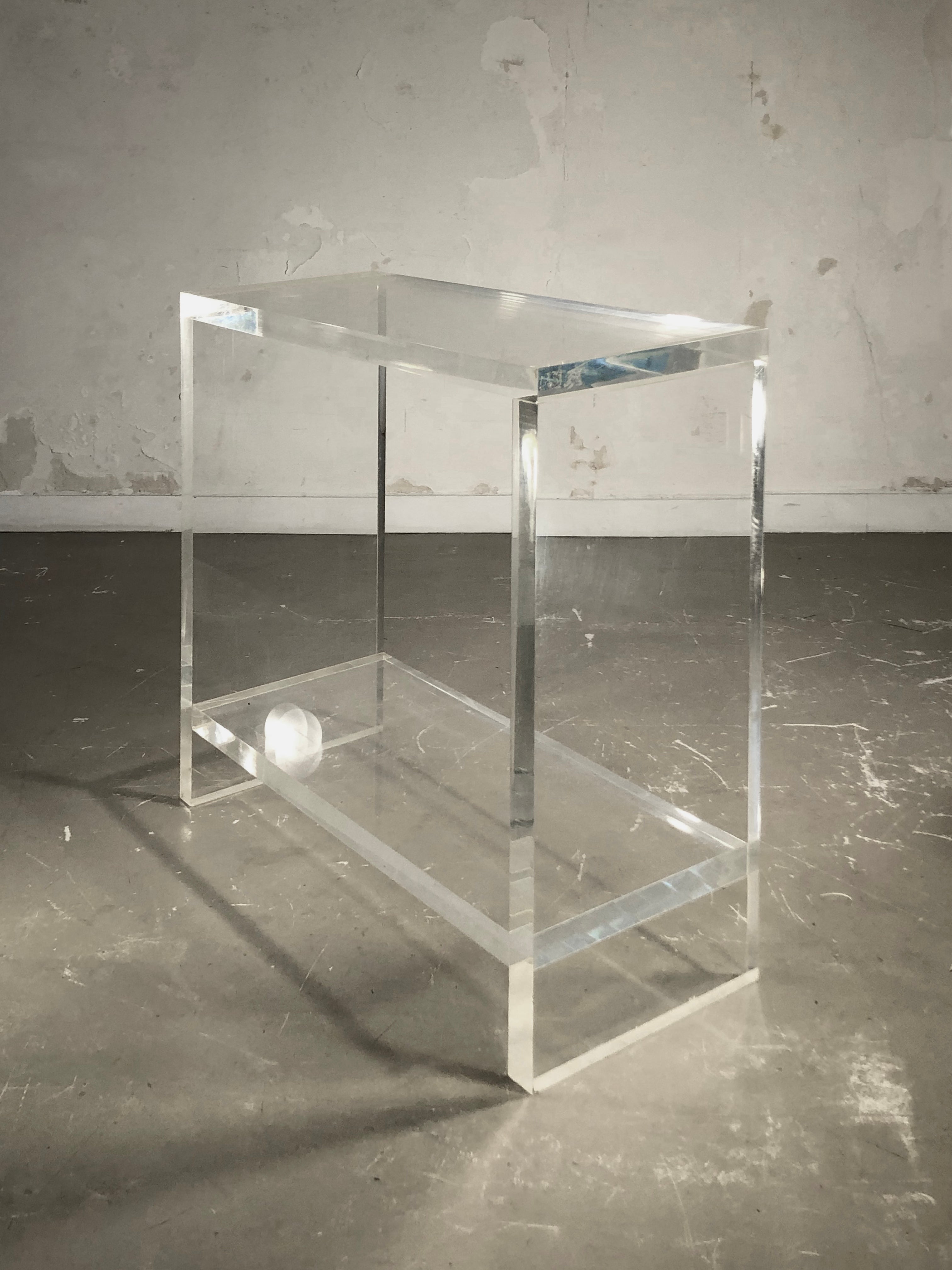 A rigorous rectangular console, Post-Modernist, Space-Age, Seventies, Shabby-Chic, geometric structure solidified by a low shelf both aesthetic and constructive, in very thick strips of transparent plexiglass resin, assembled and glued, to be