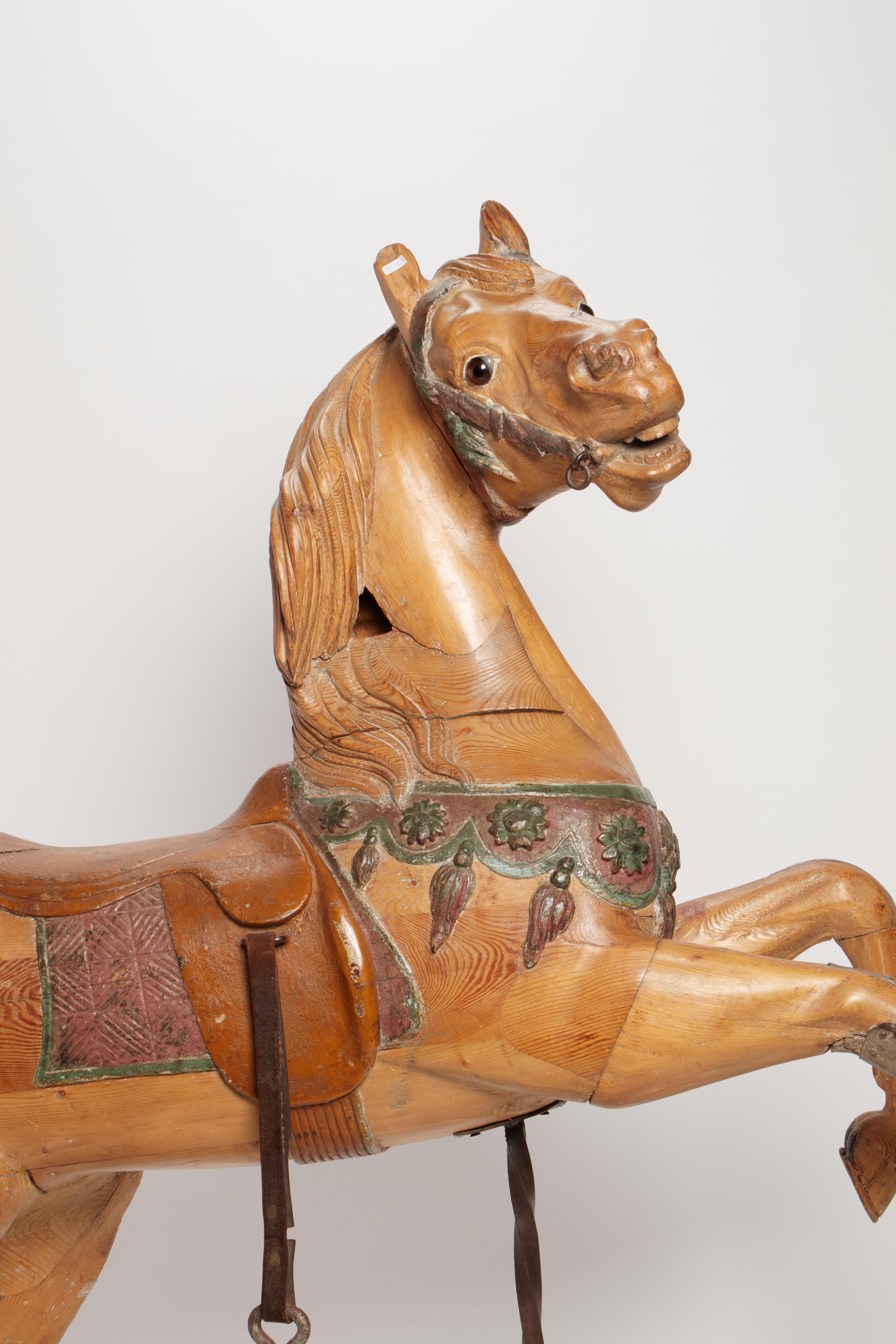 A rampant carousel horse. Original iron front stand and one of the stirrups. The sculpture shows a peculiar movement of the body and the head, specifically of the Maison Bayole. The extensive presence of original colors, Paris, 1890.