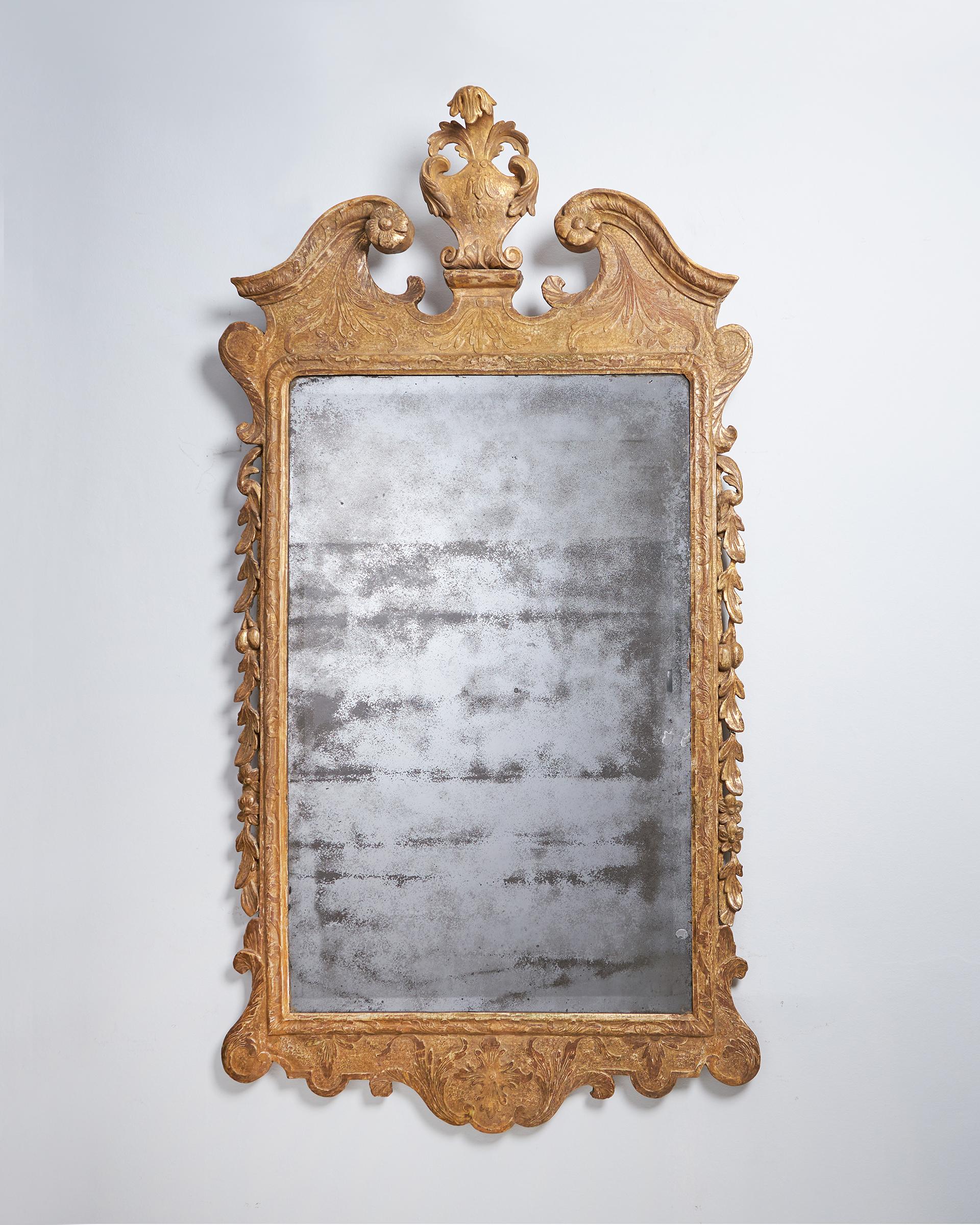 A fine and rare early 18th century George I Gilt Gesso pier or console mirror, circa 1720-1730

The period bevelled mirror plate sits within an upright lobed moulded gilt frame flanked by cascading carved foliage below a broken swan neck pediment,