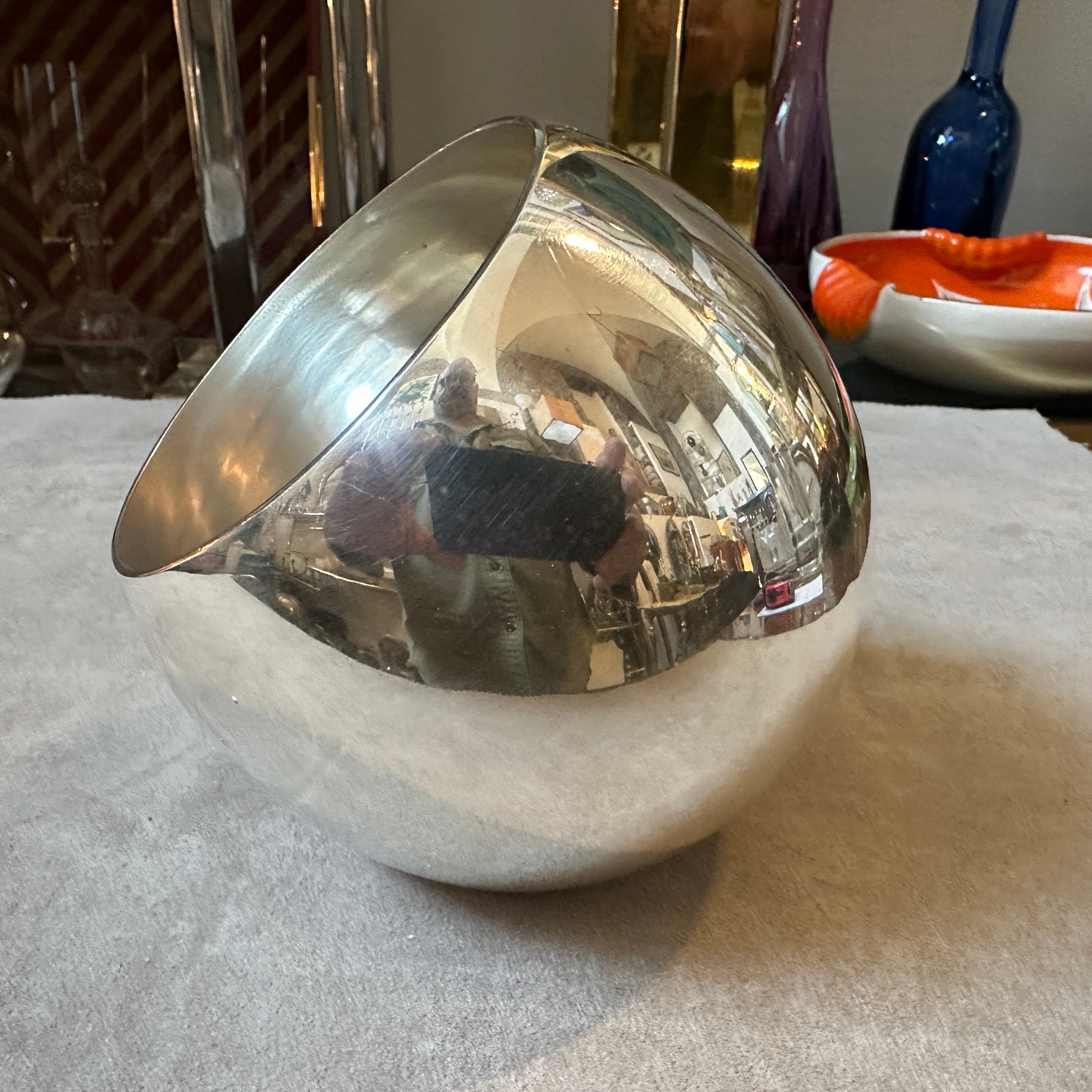 This post-modern vase designed by Lino Sabattini exemplifies the clean, sleek aesthetic typical of Sabattini's work and the minimalist movement of the era. This vase features a perfectly round, smooth form that emphasizes simplicity and elegance.