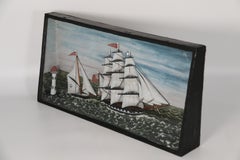 A rare 19th century folk art diorama of two sailing vessels racing at sea.