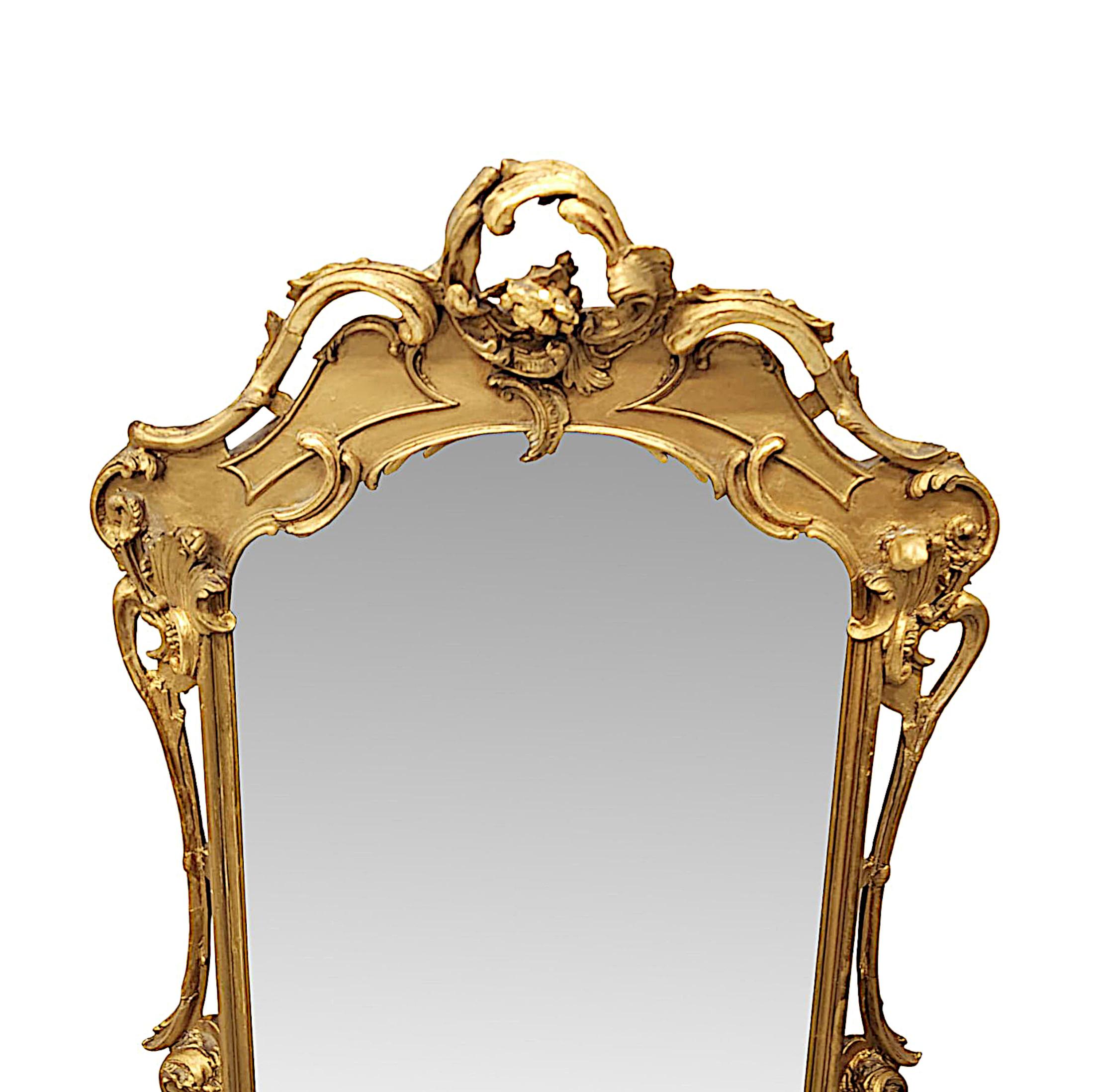 A rare 19th Century giltwood pier, hall or dressing mirror, finely hand carved and of exceptional quality.  The original, shaped mirror glass plate is set within a stunning pierced, moulded and fluted giltwood frame which is profusely and