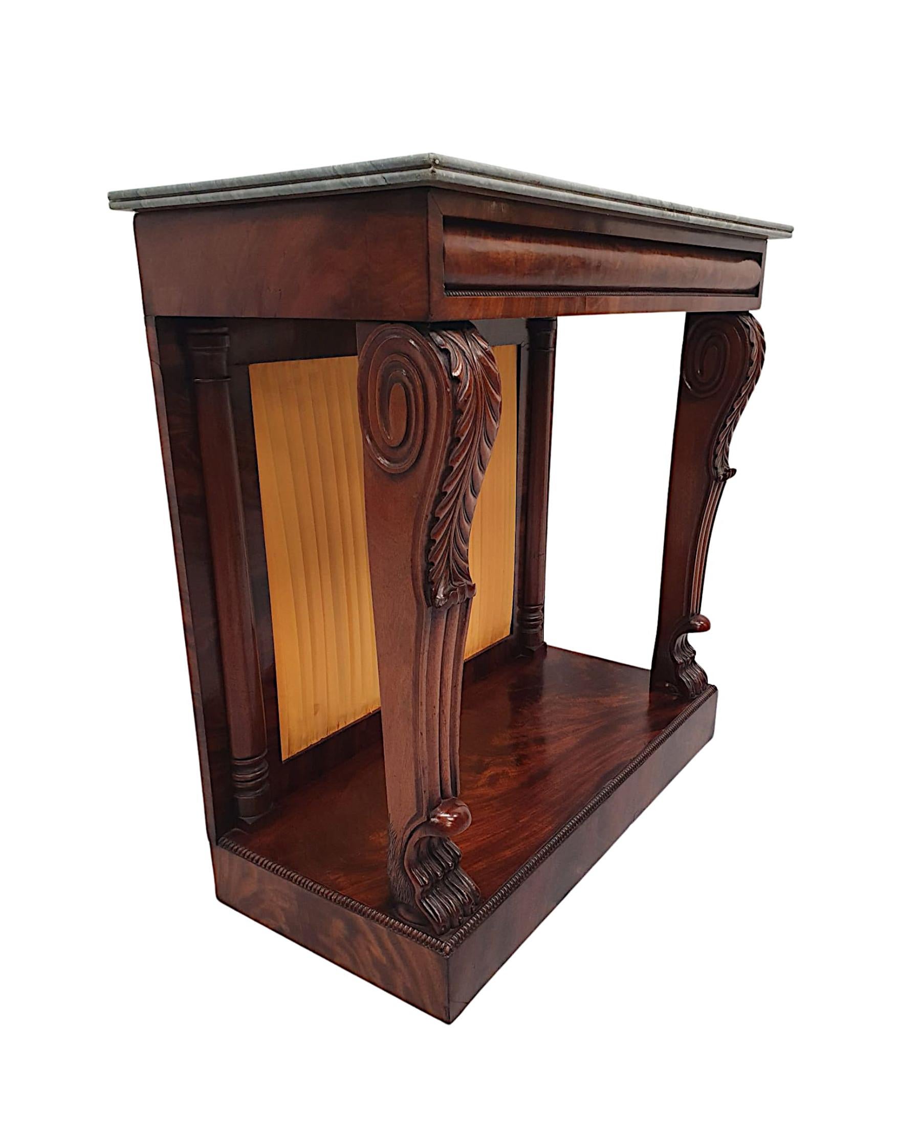 A rare 19th century mahogany marble top console table, of neat proportions, fabulous quality and finely hand carved with rich patination and grain. The moulded emperador marble top is raised over an elegant, moulded convex frieze with beading motif