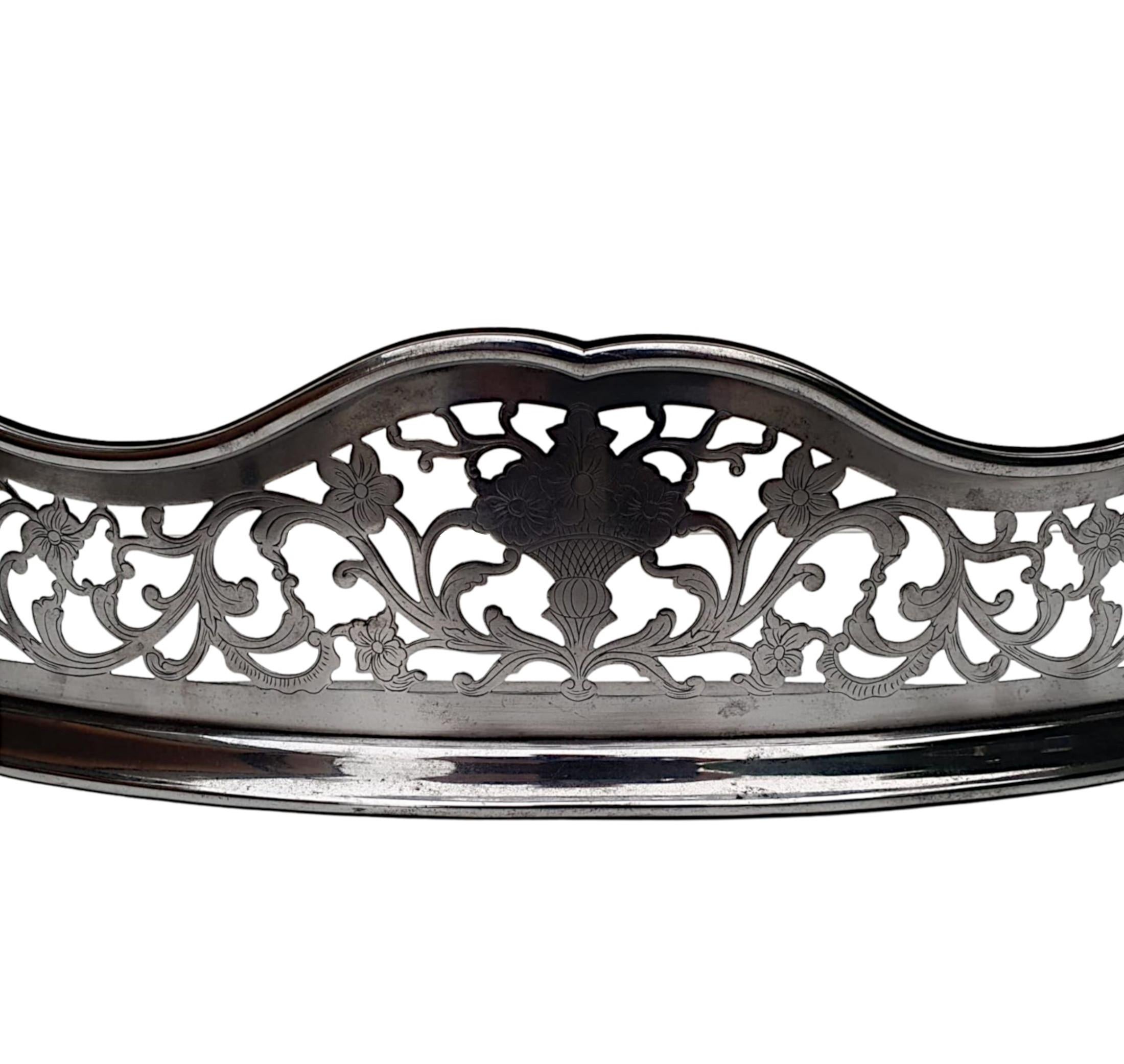 A Rare and fine 19th century polished steel curb fender. The rolled top raised over pierced and shaped bowfront frieze with elegant scrolling foliate, flowerhead and dragon motif detail, supported on stepped platform base. 

Depth measured at